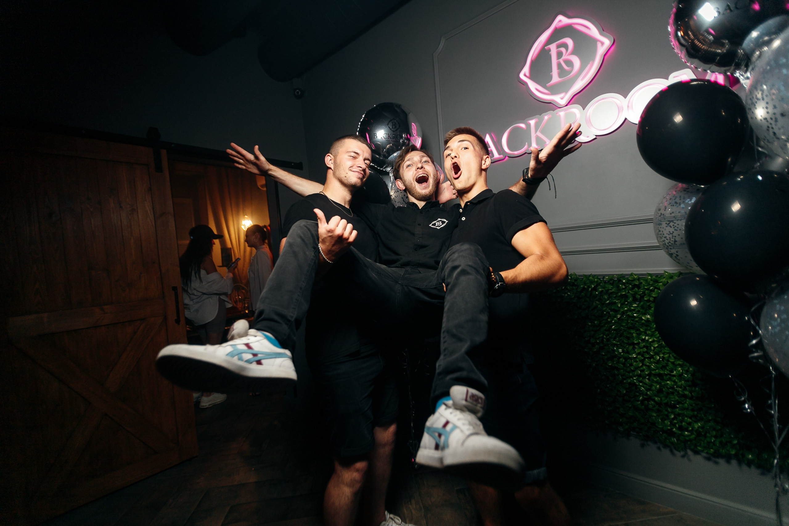 People dancing with balloons at birthday party