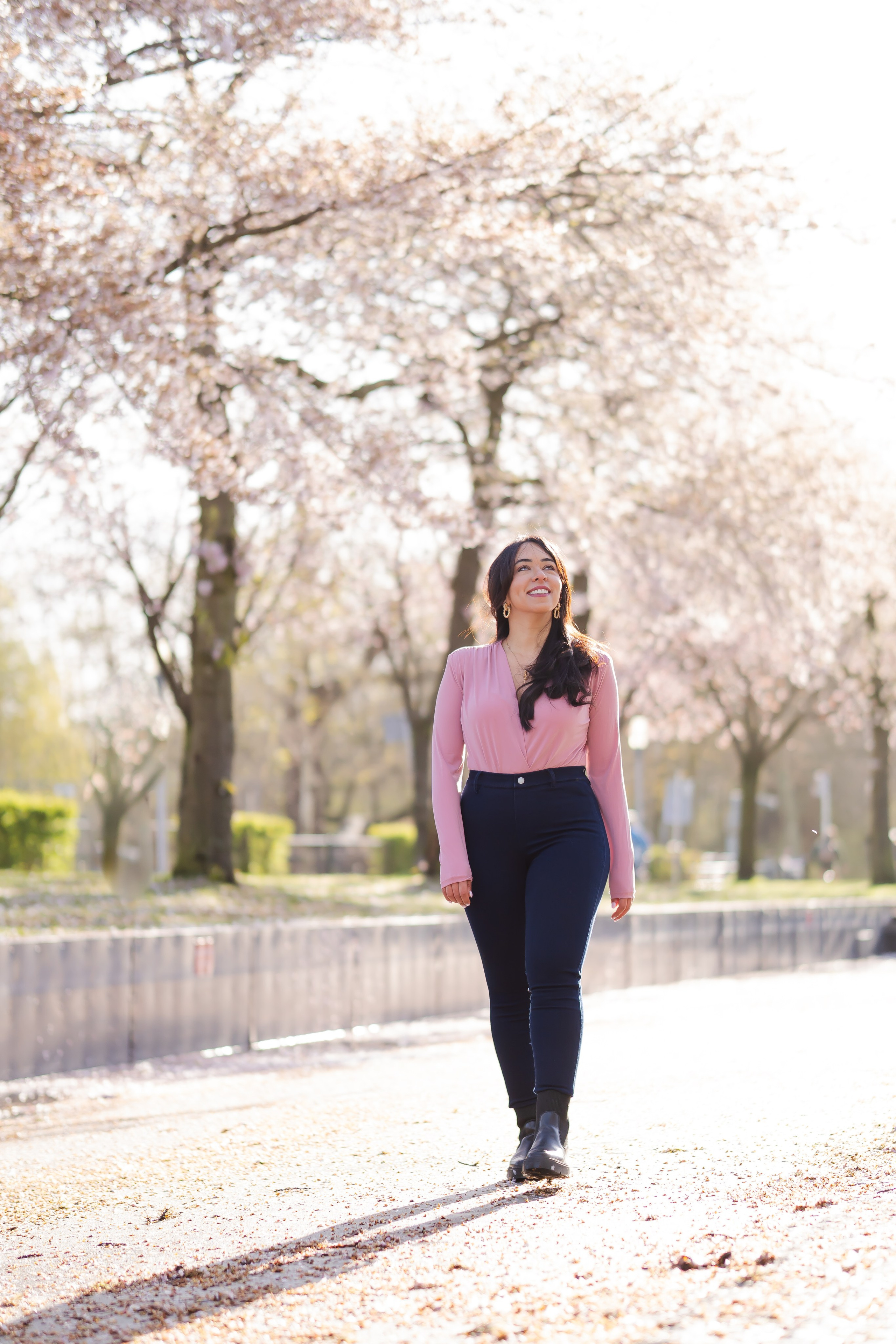 girl walking in a cherry blossoms garden