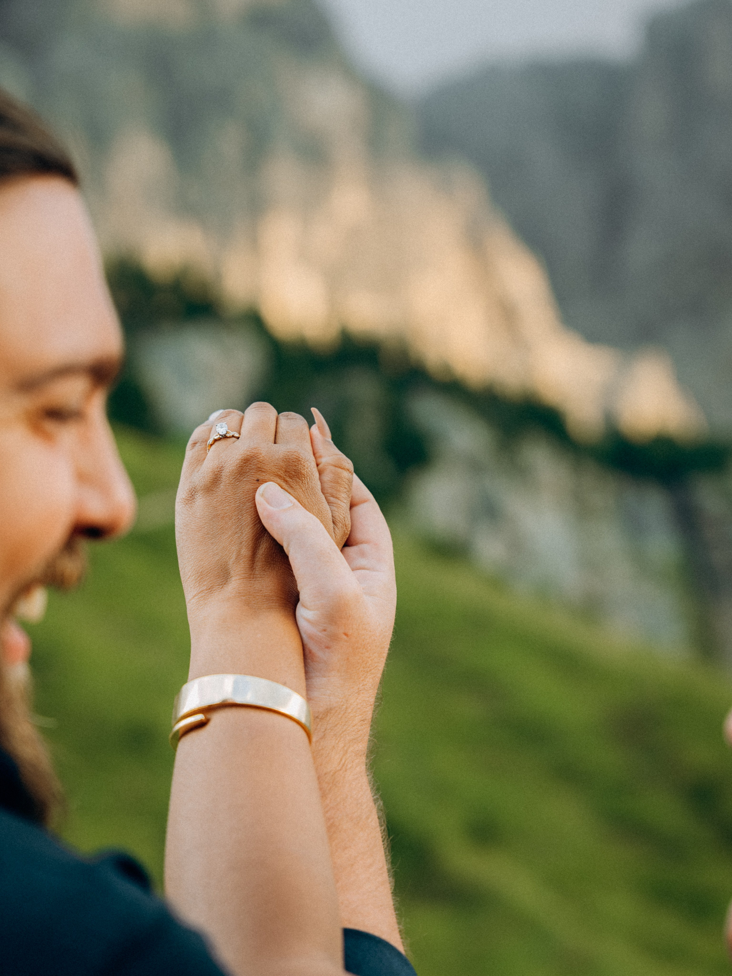 Detail shot of intertwined hands during engagement session in Ortisei