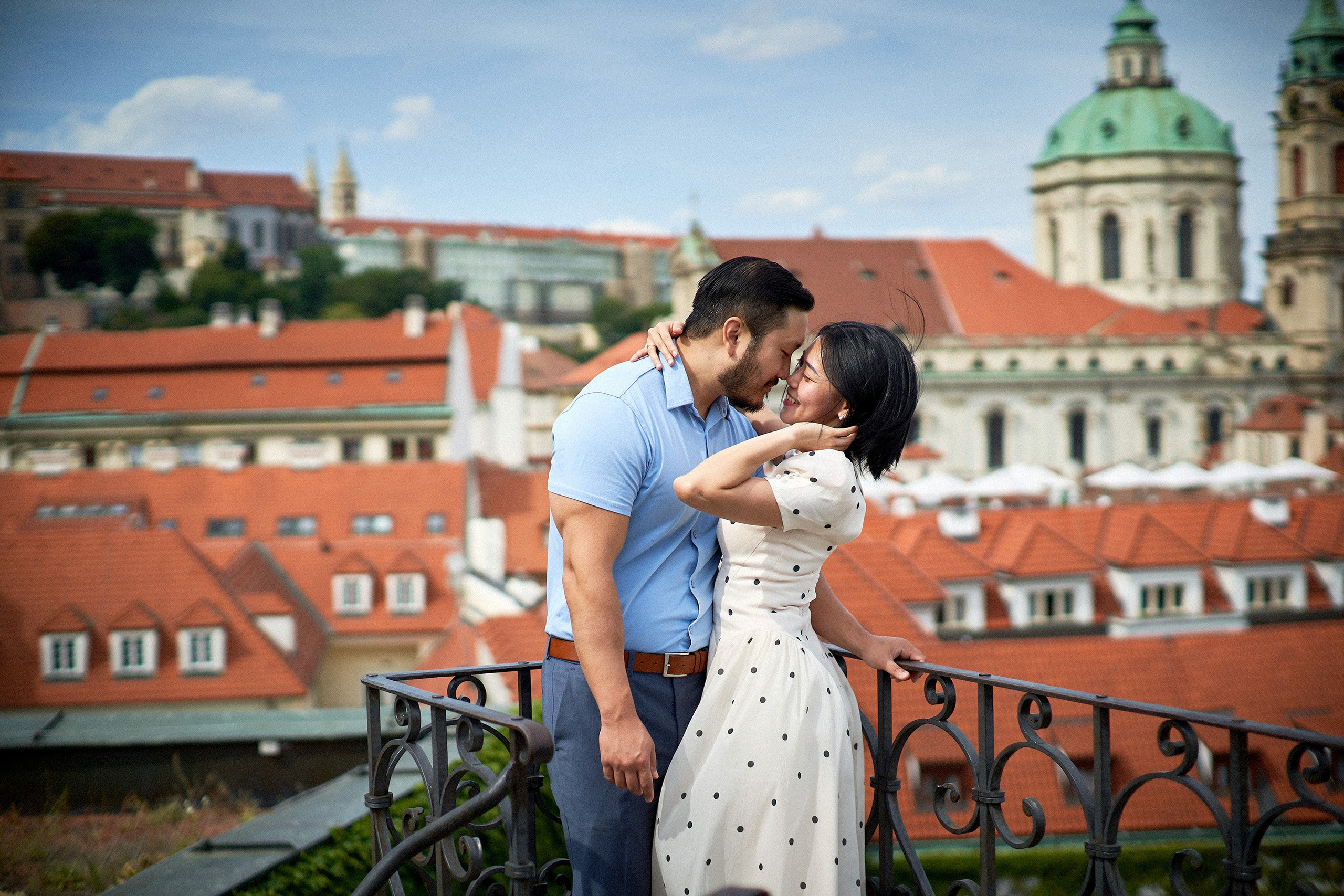 Engaged couple sharing a sensual embrace during their session in Vrtba Garden. 