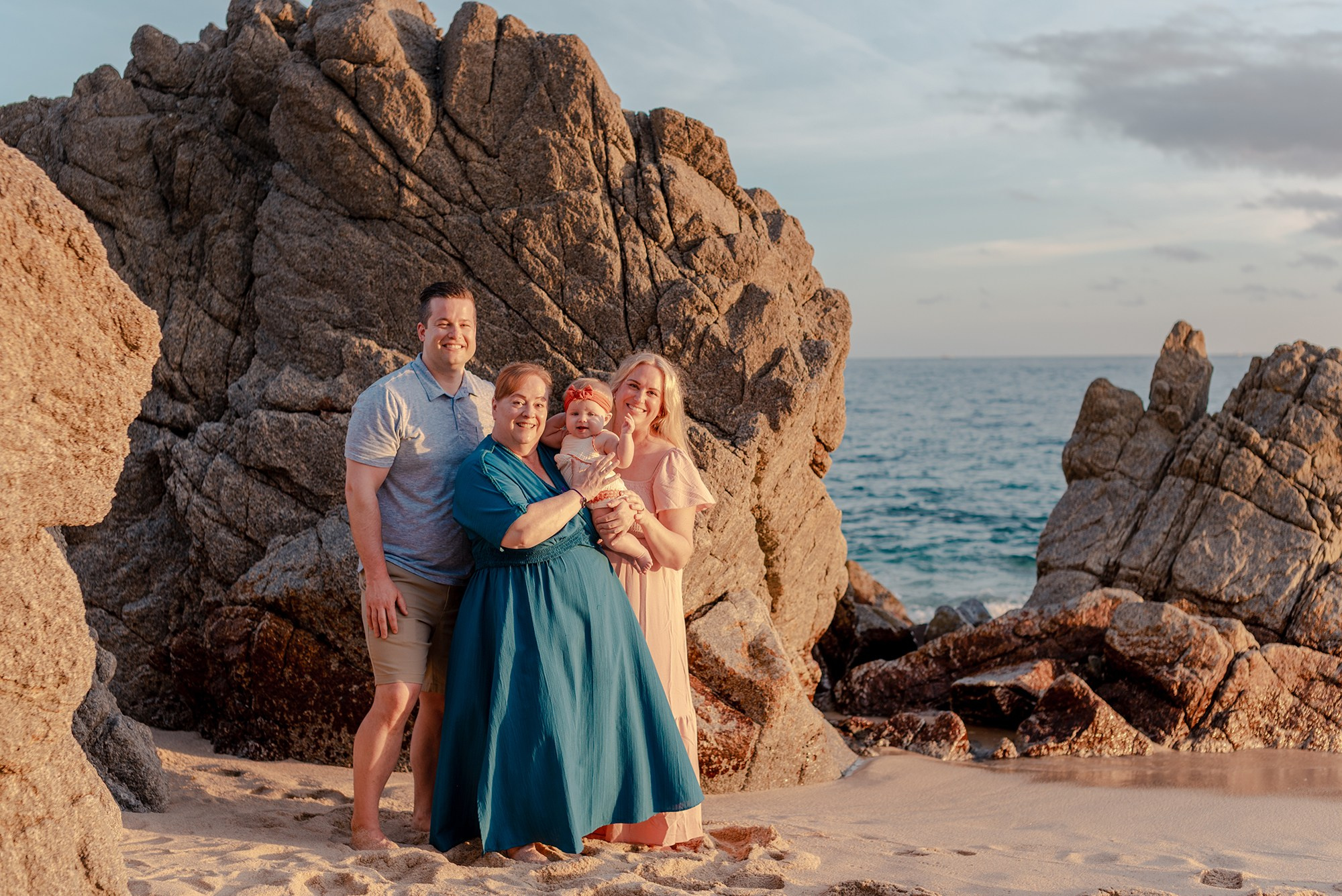 Mother father baby and grandmother during vacation family photography session at Playa Monumentos near El Arco Cabo San Lucas