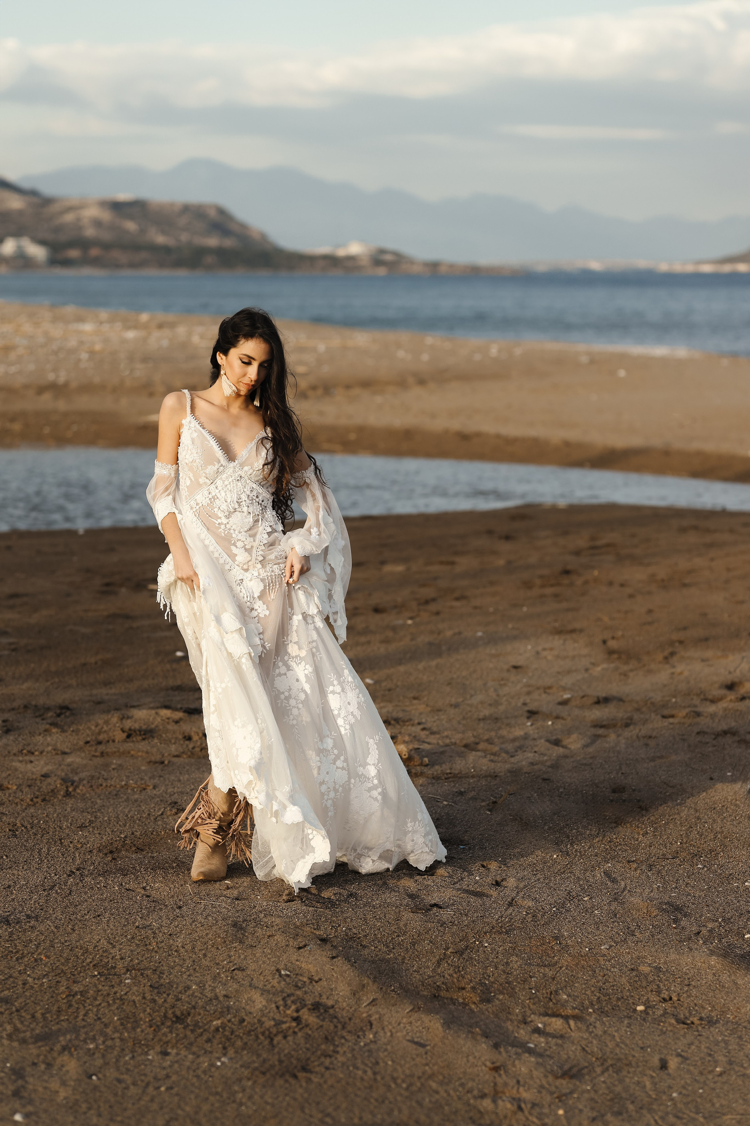 A portrait of girl in a wedding dress next to the sea. Rhodes, Greece