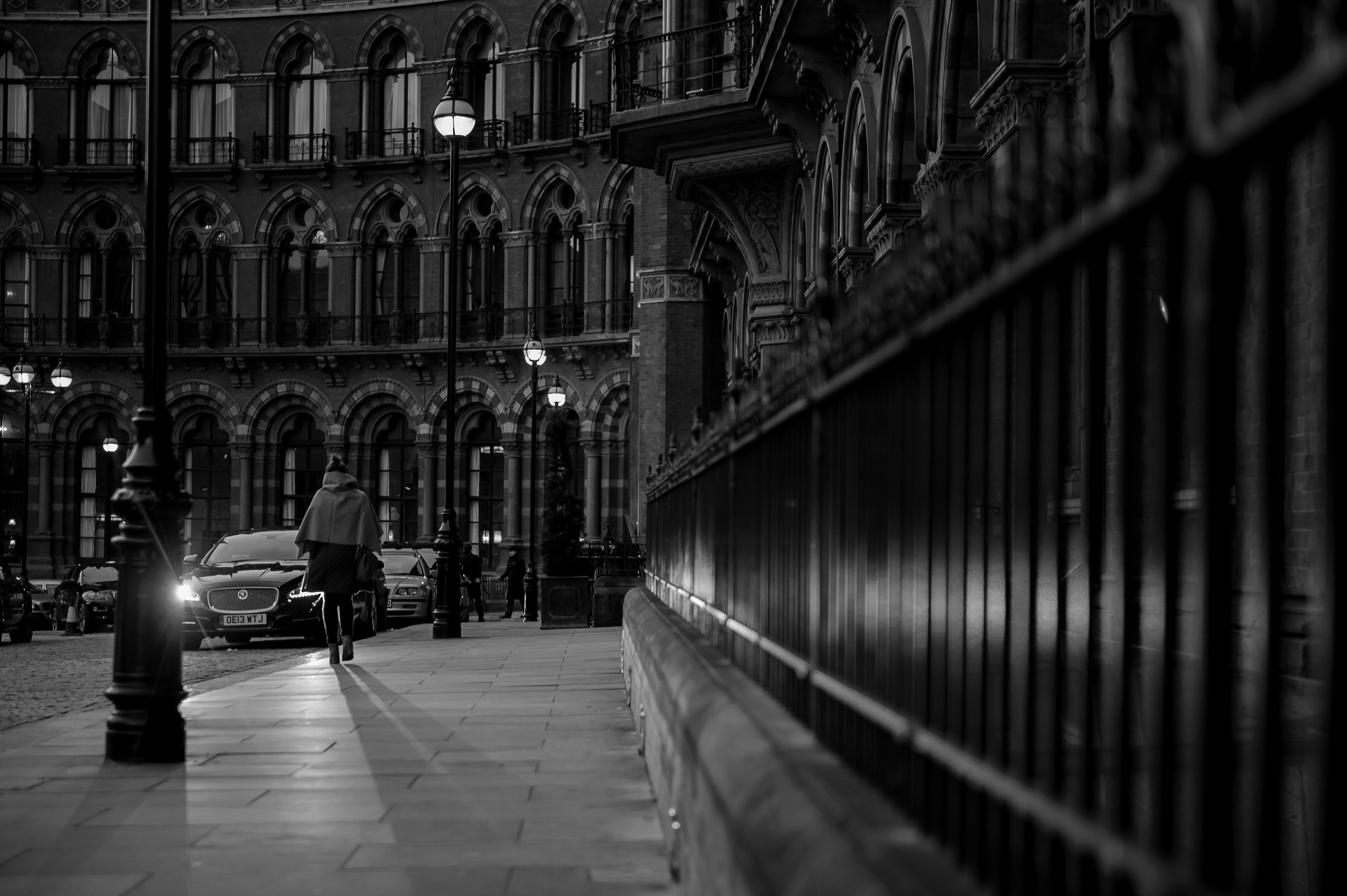 Cinematic black and white portrait of a woman walking in London