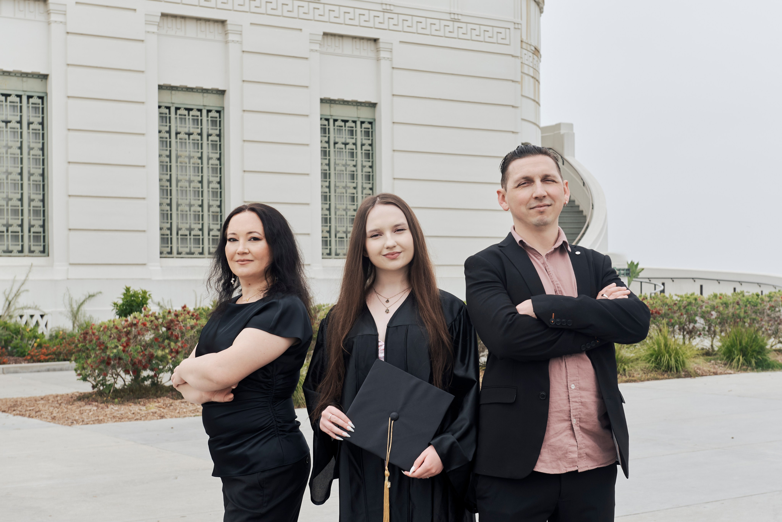 Graduate taking a celebratory selfie in front of the Los Angeles City Hall