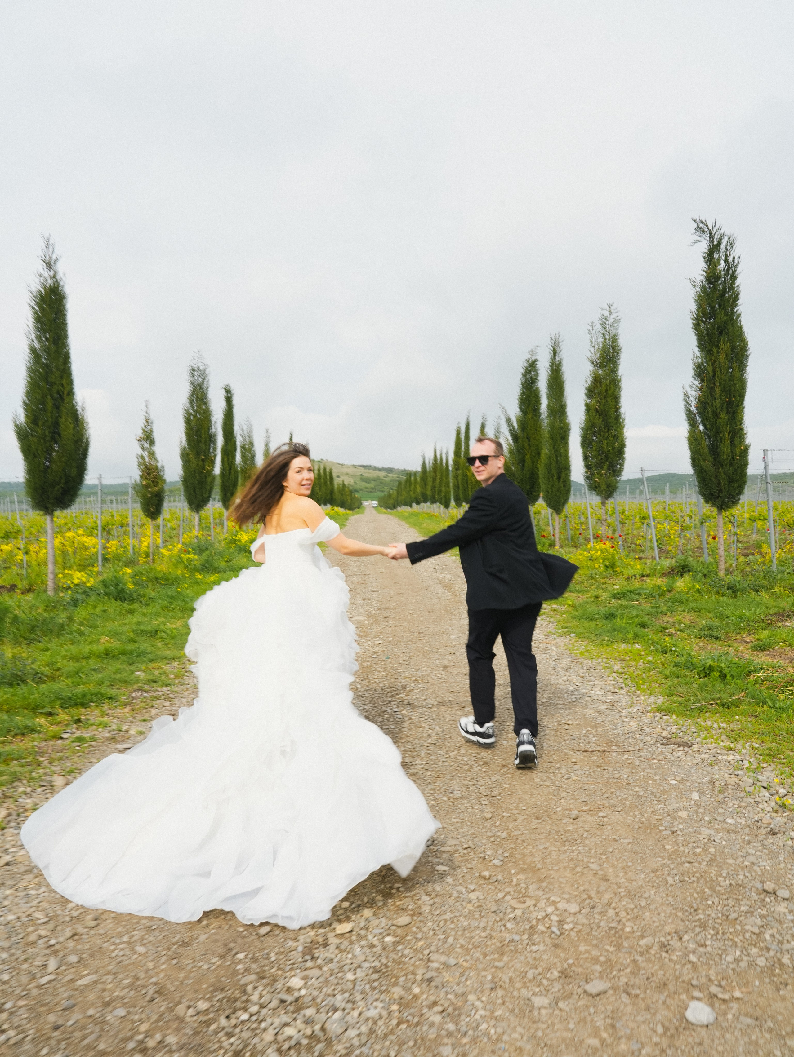 Couple running through vineyards in Kakheti 
