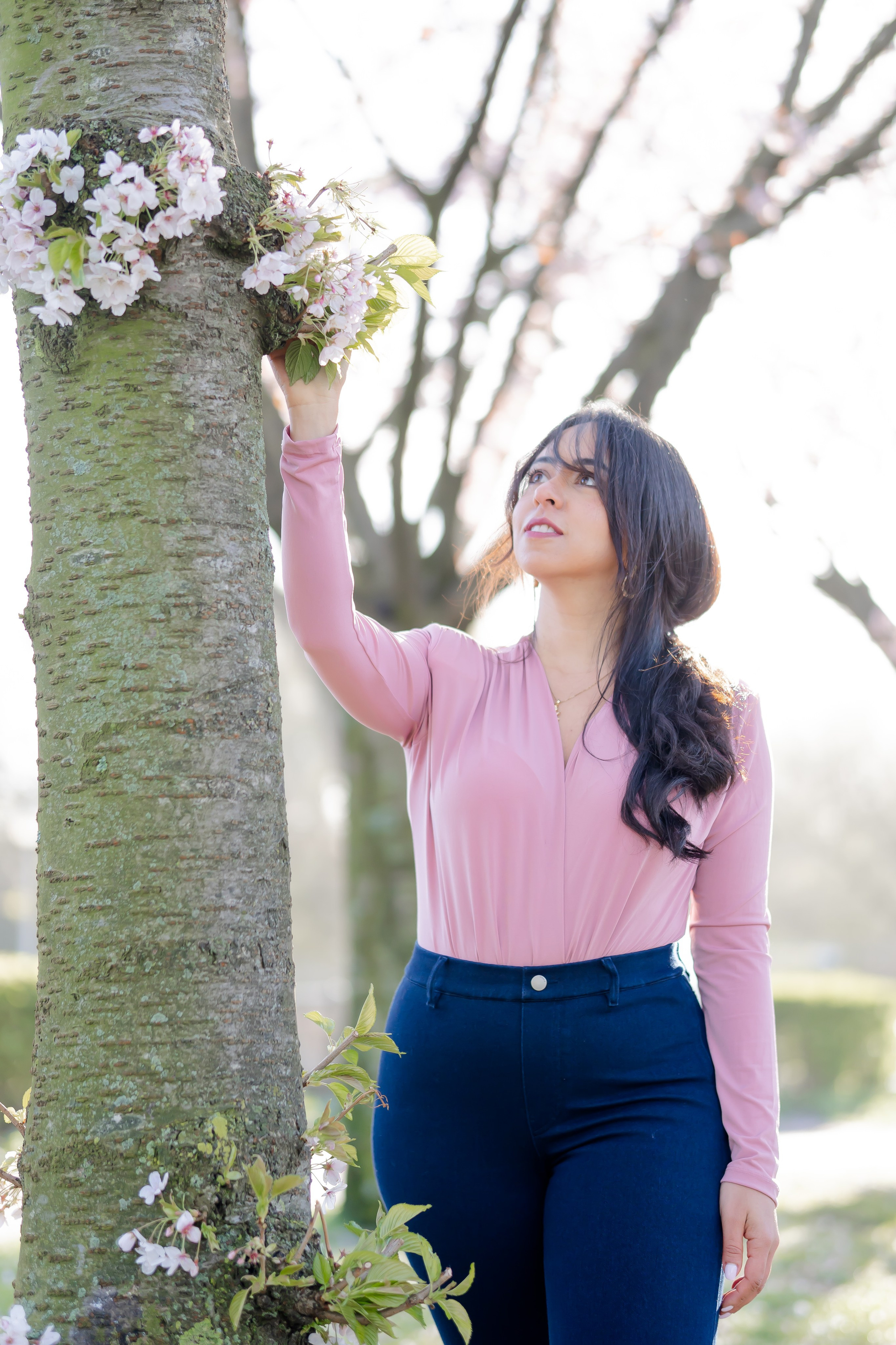 girl standing near a cherry blossoms garden in Netherlands