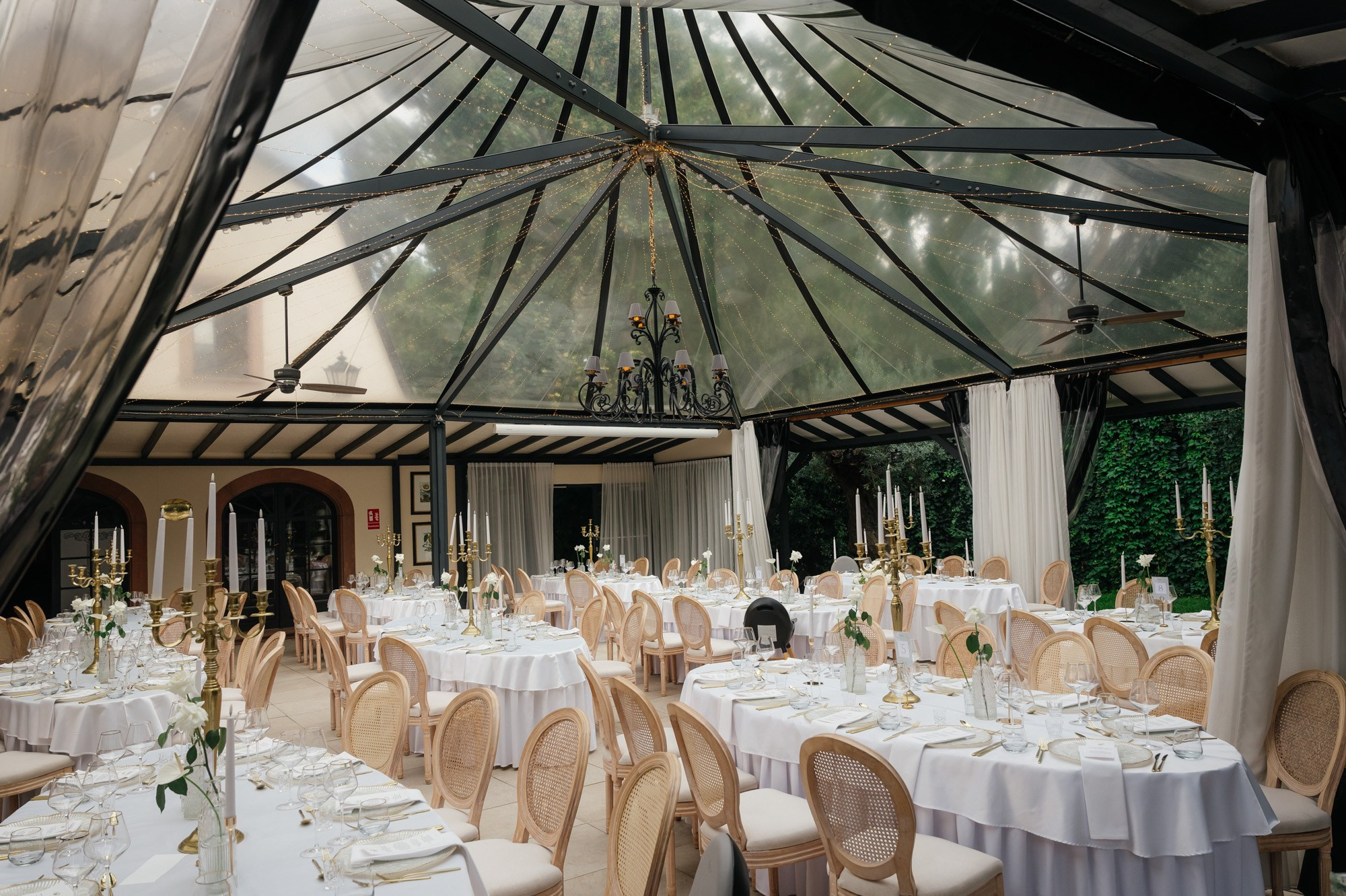 Tables set for dinner in the glass pavilion at the Morrhof