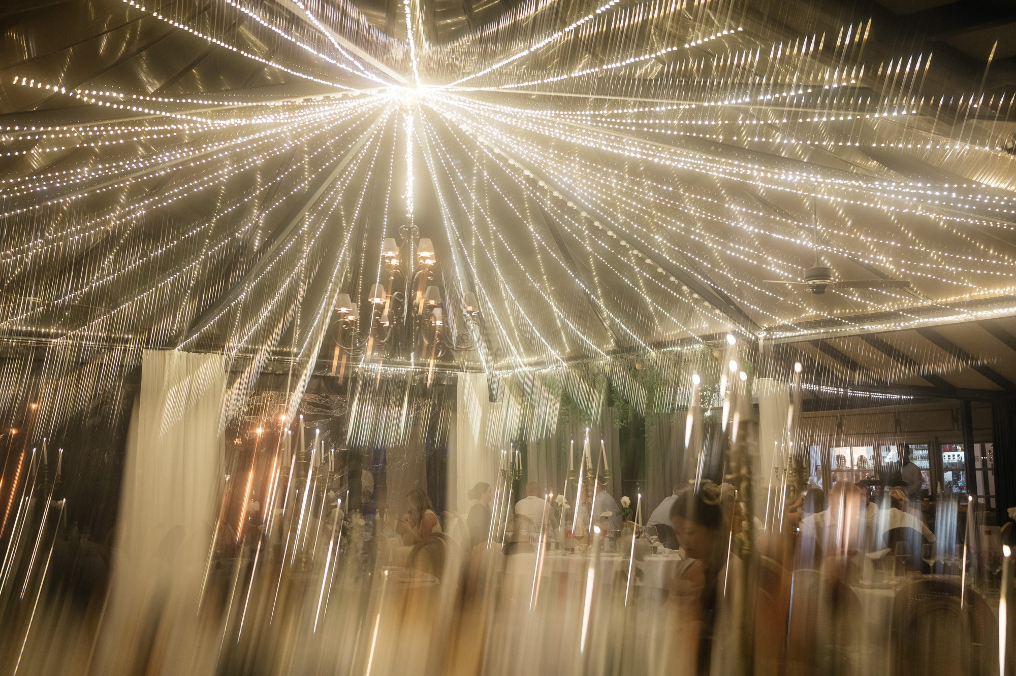 Chandelier in the glass pavilion with a long exposure light effect
