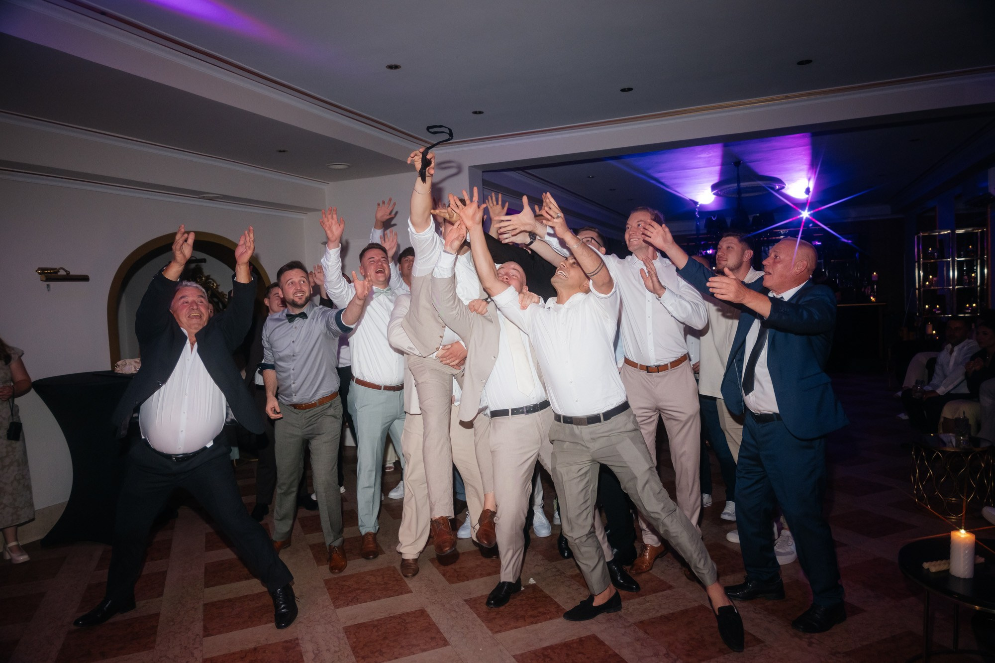 Men cheering on the dance floor
