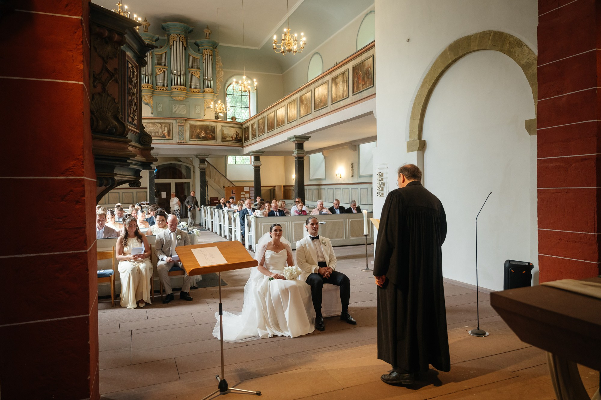 Inside Bergkirche Osthofen with the organ gallery during the ceremony
