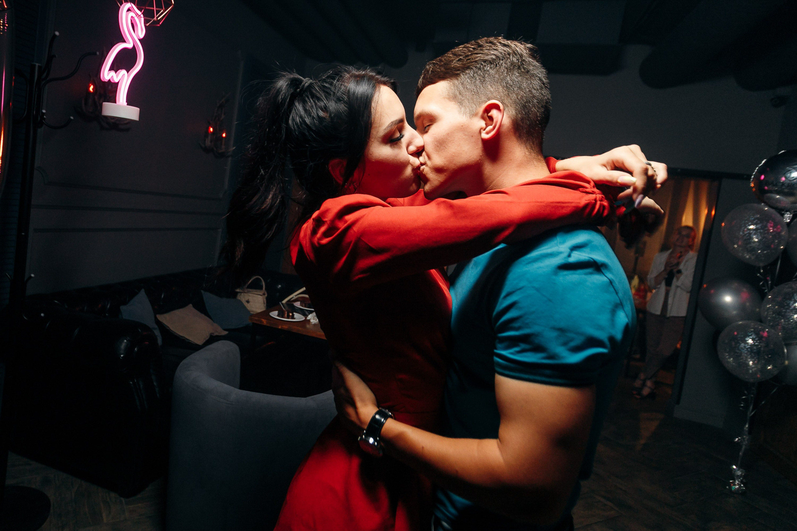 Couple kissing at nightclub, romantic moment