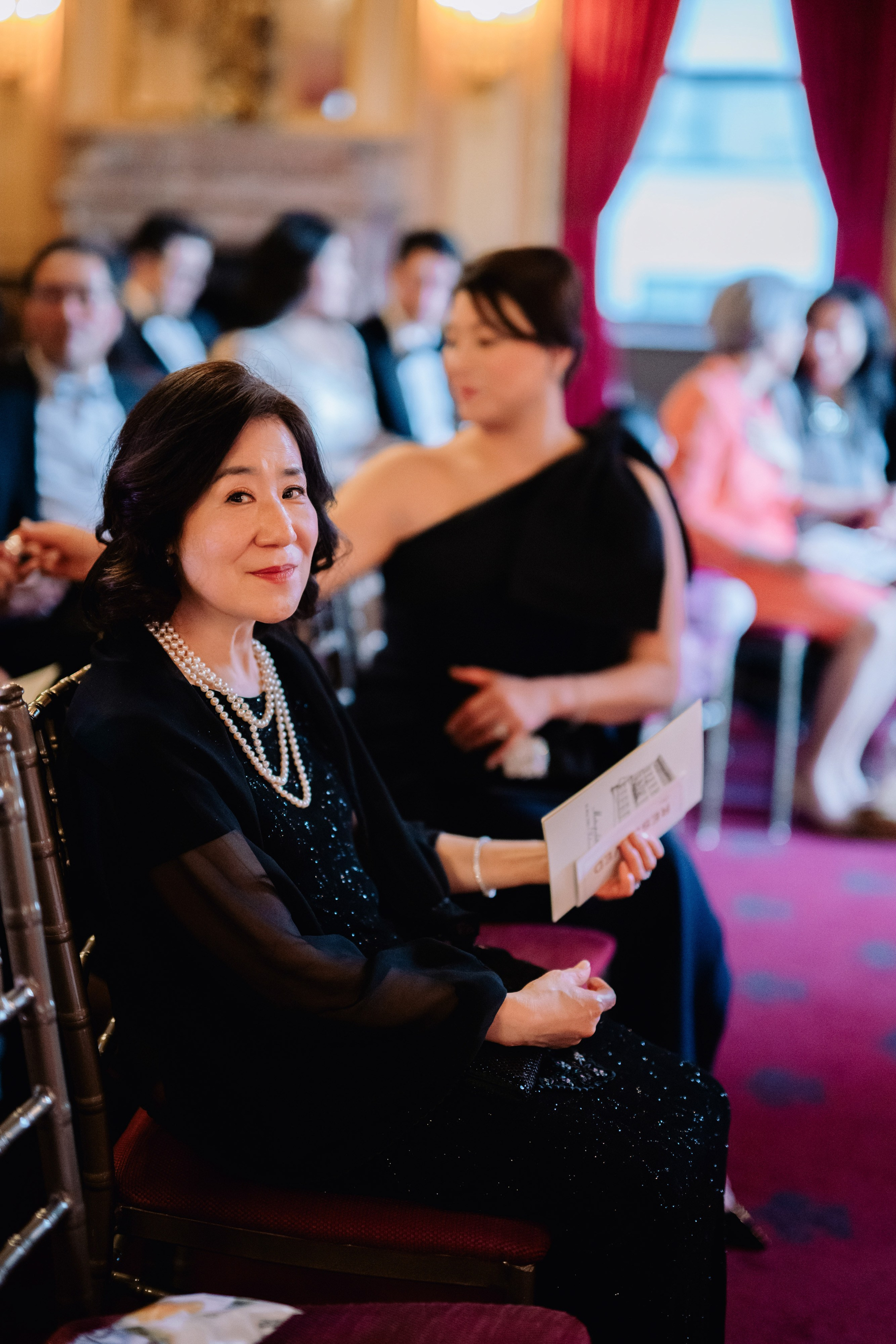a woman sitting in a chair with a book