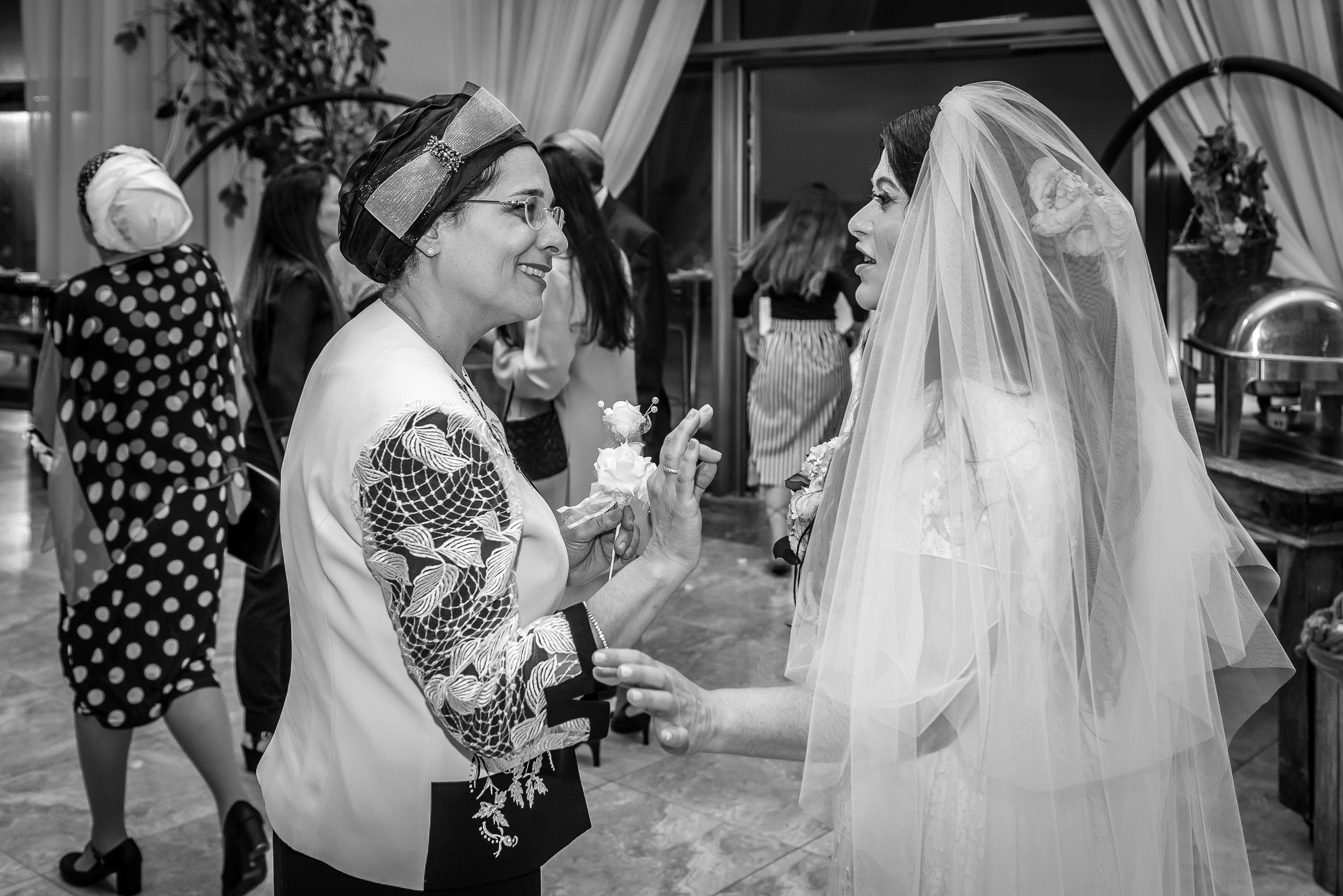 Bride Simone talking with a wedding guest during the reception at the Leonardo Hotel in Haifa, Israel