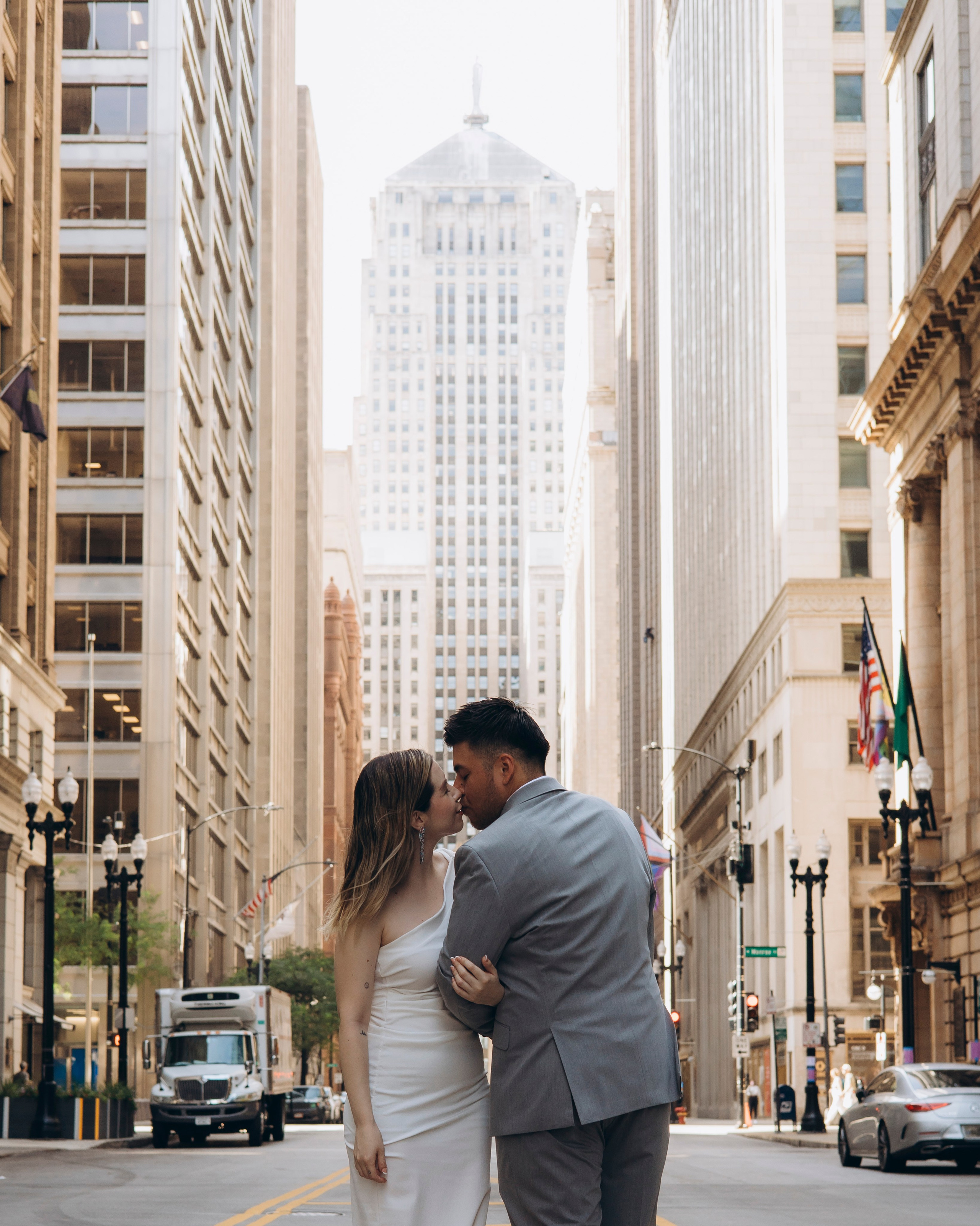 Couple kissing with Chicago skyline in the background during wedding photoshoot