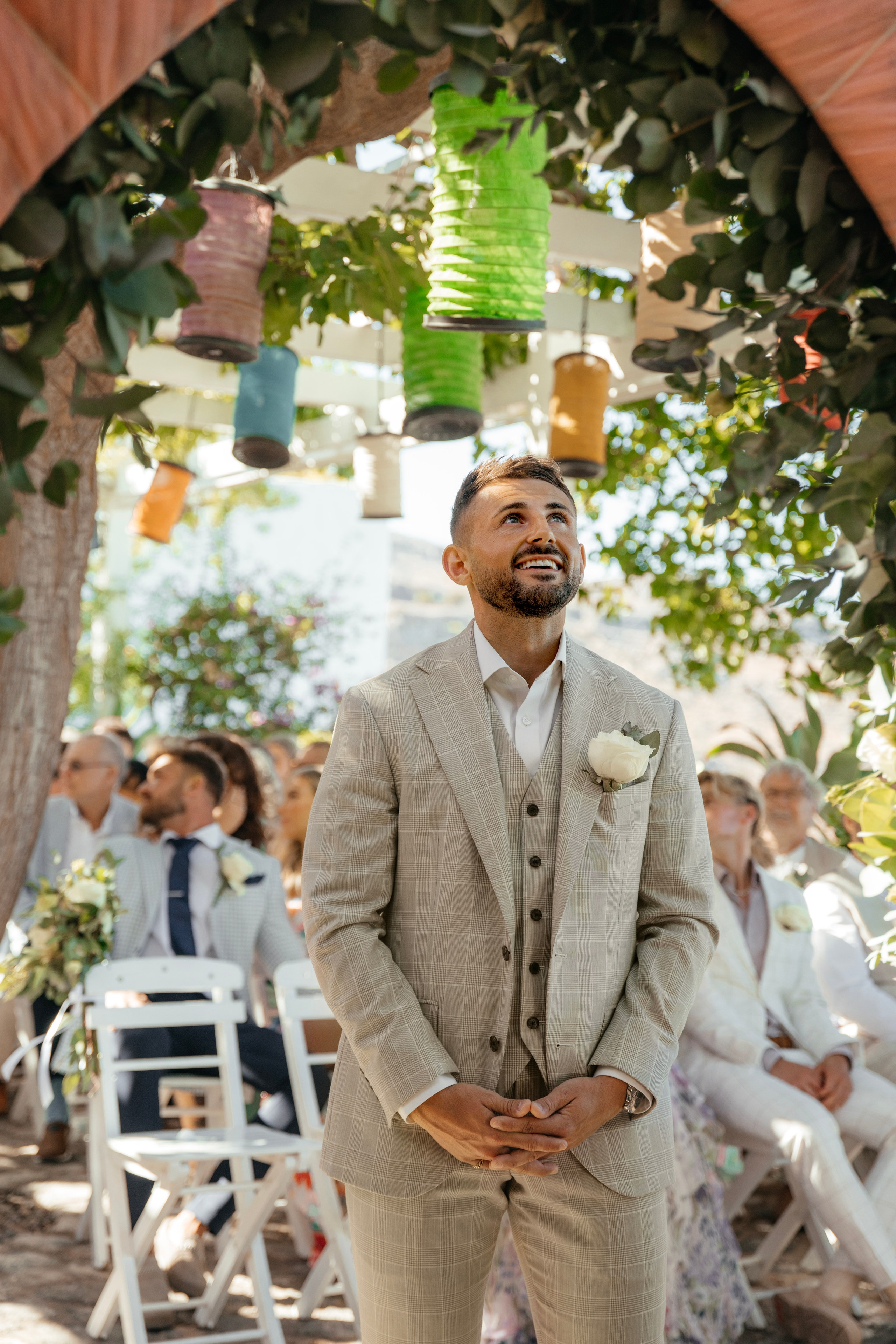 Groom smiling as he waits for his bride in Lindos, Rhodes, Greece