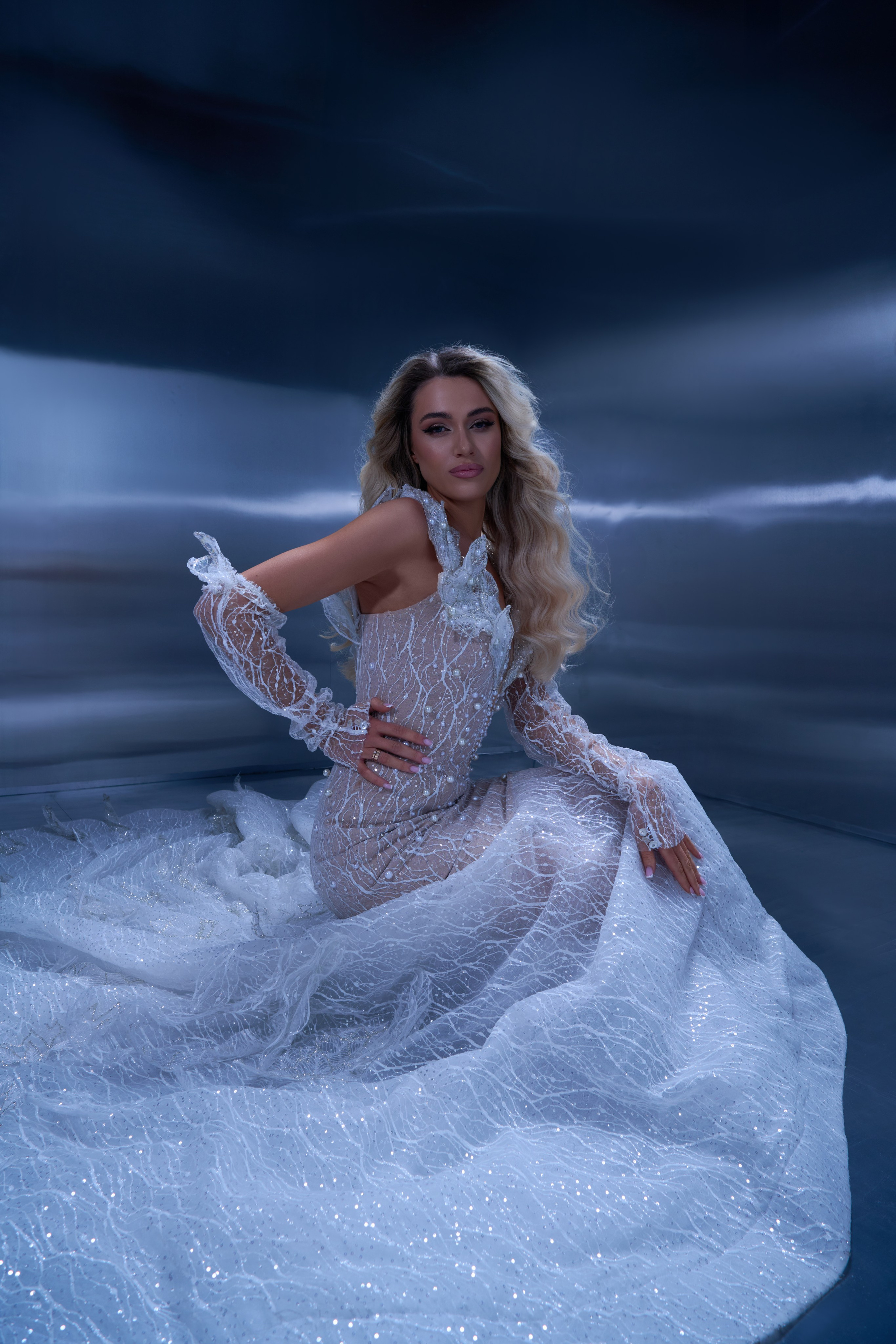 Fashion model in glittering couture dress captured with fan light in Warsaw photography studio