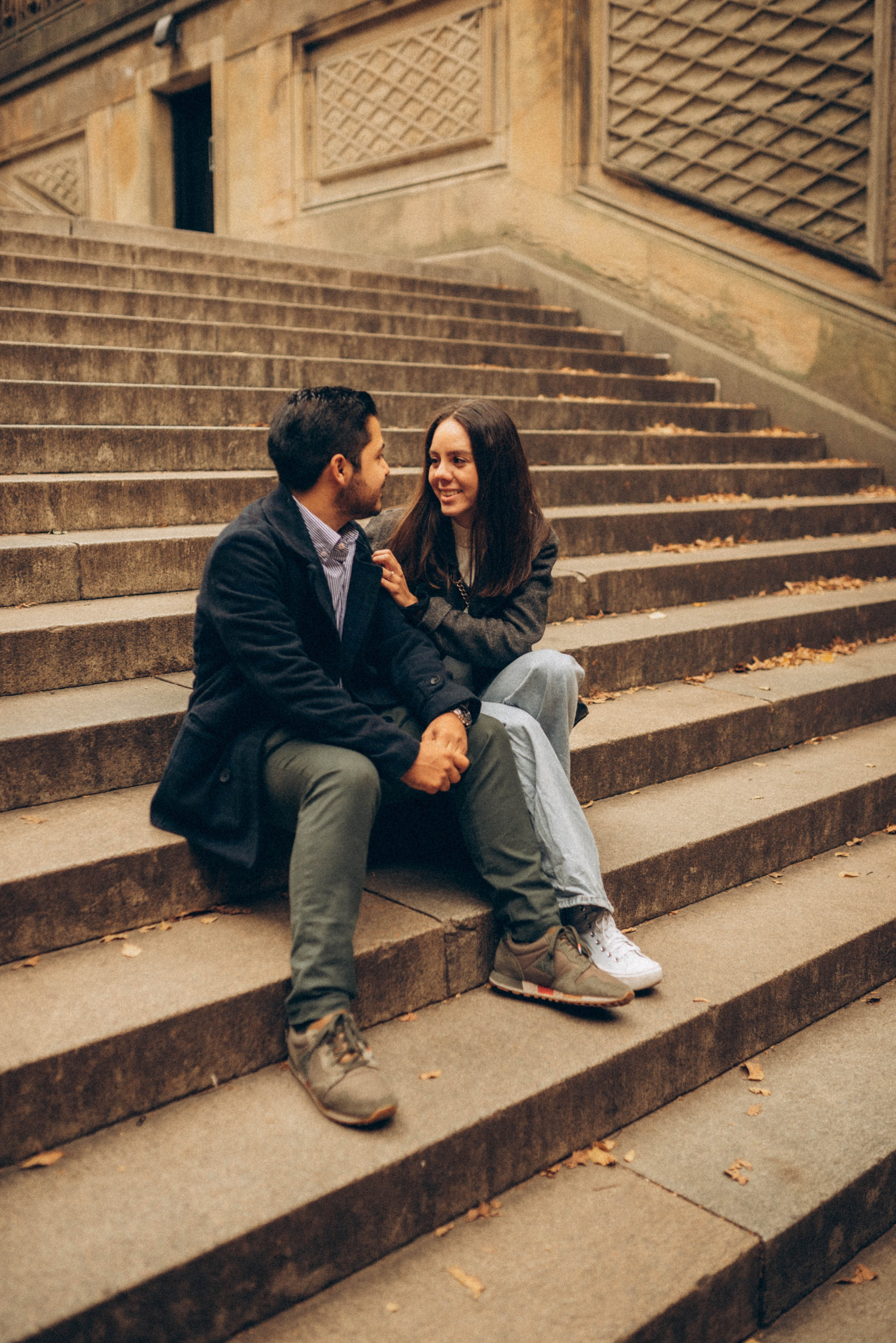 Man proposing in Dumbo with carousel behind.