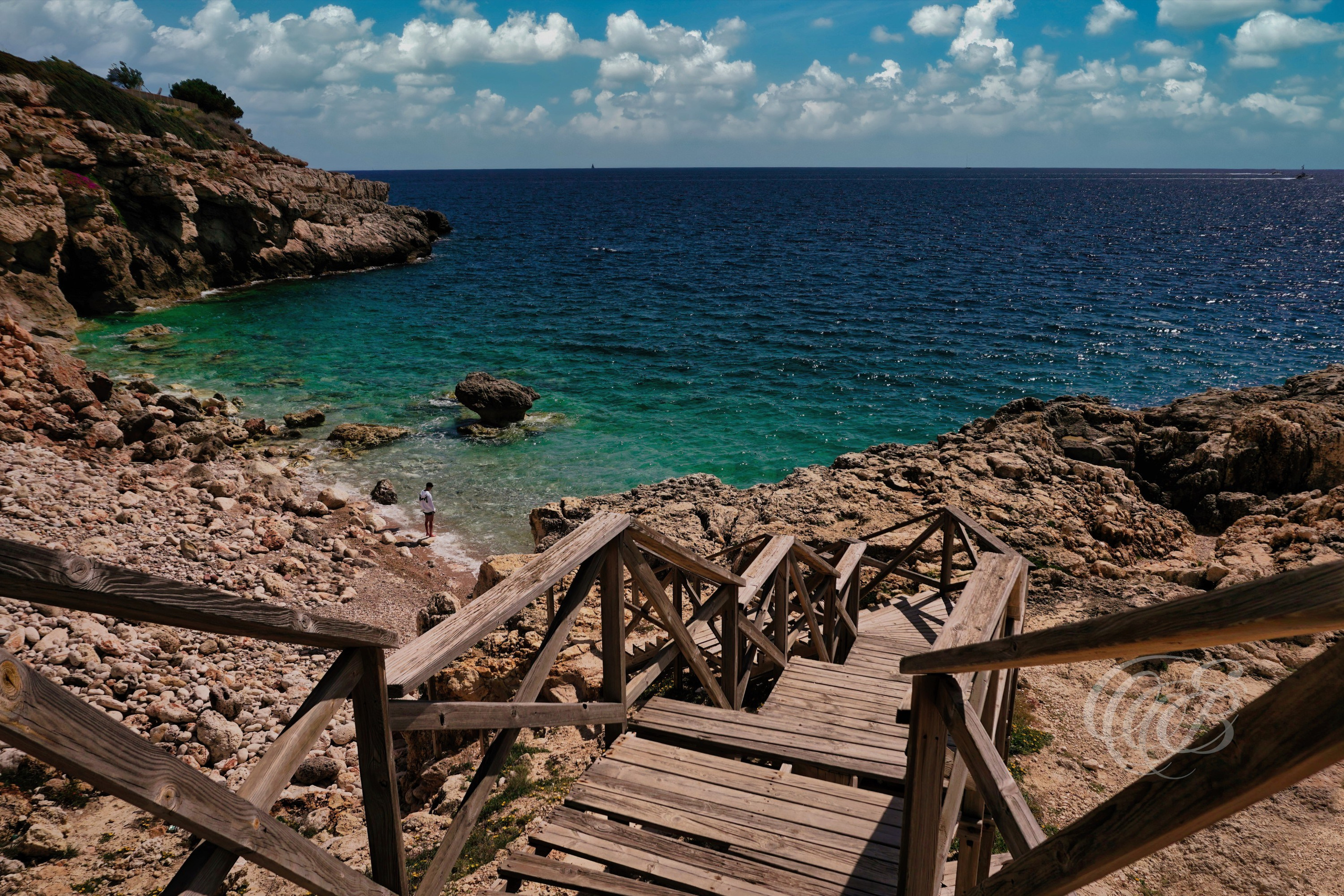 Punta des Grells Beach is part of the rugged coastal scenery that defines sections of Mallorca’s Mediterranean shoreline. Known for its rocky formations, clear waters, and quieter natural setting near Palma, the area reflects the balance between the island’s coastal geography and the surrounding Mediterranean landscape. This view captures the calm atmosphere and natural character of Punta des Grells within the Balearic Islands. Eduardo Bartoli Photography.