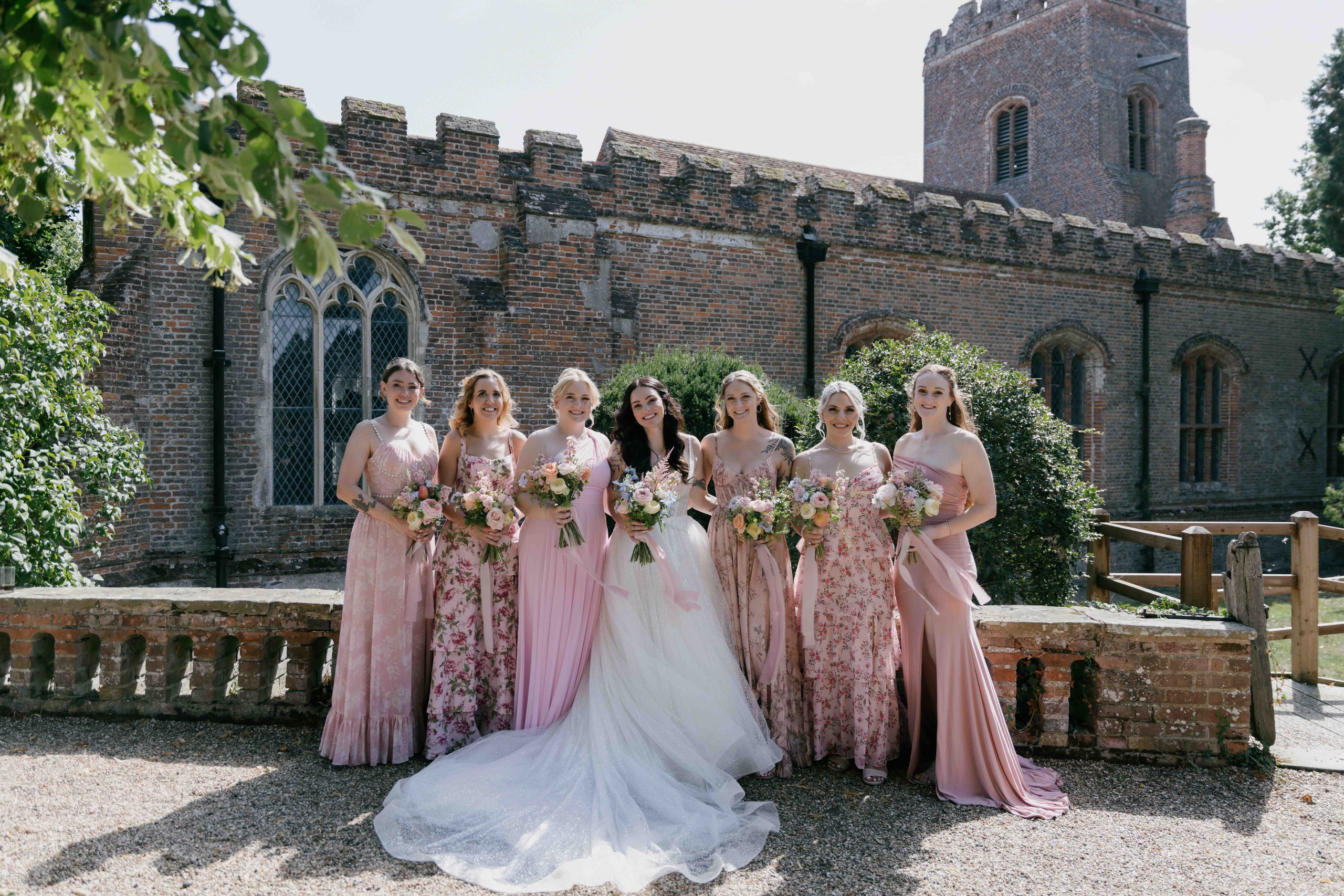     bridesmaids in pink dresses Layer Marney Tower summer wedding