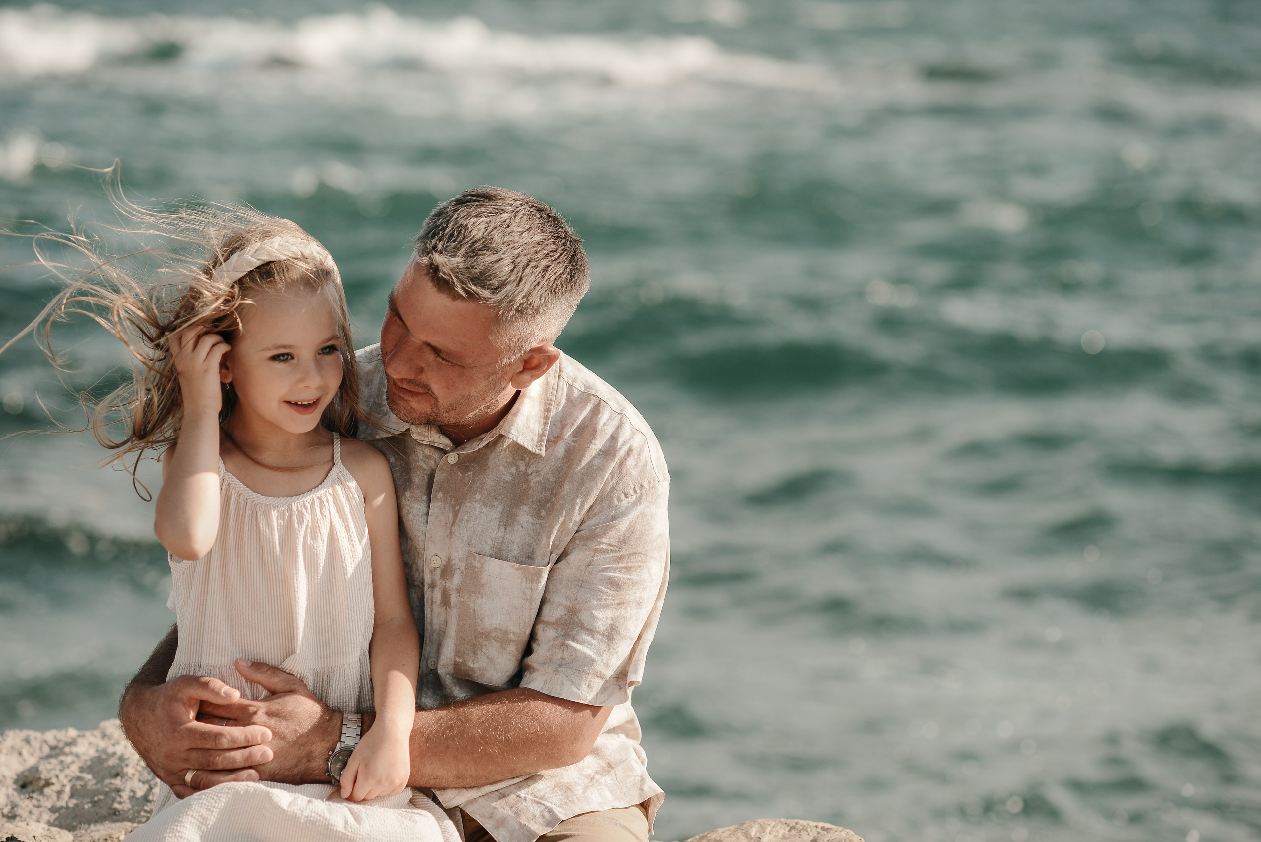 Father and daughter by the sea during a golden hour family photoshoot in Puglia, Italy, Gallipoli