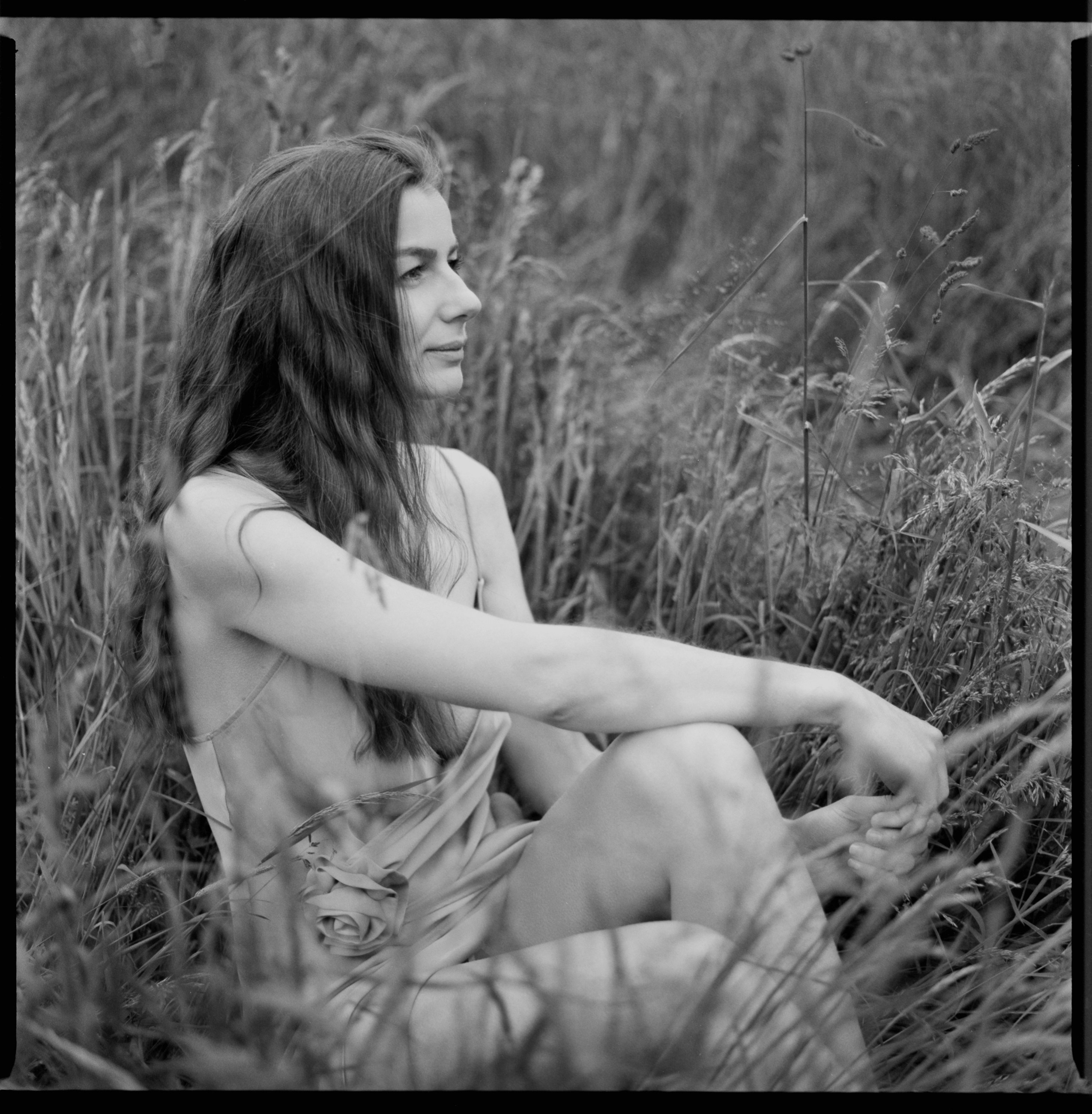 Woman in tall grass, natural light analog portrait on medium format film, Lindau