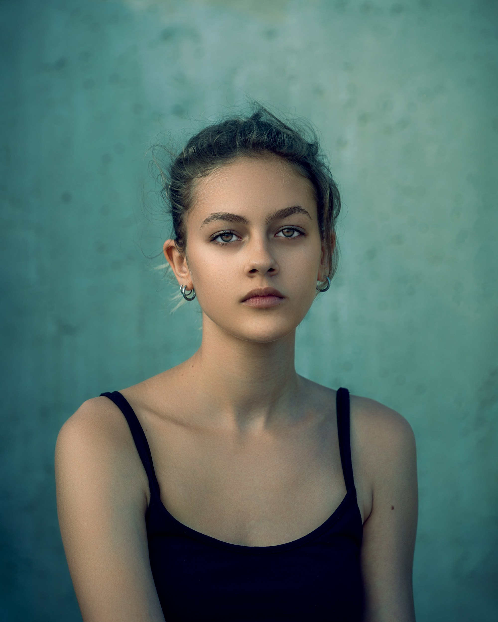 Minimal studio female portrait on blue background, fine art photography