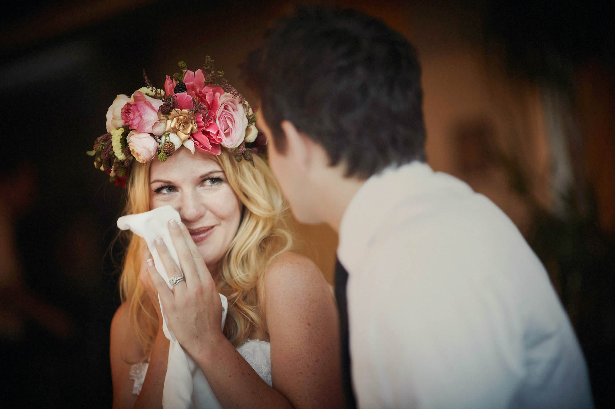 The bride tears up in happiness as she smiles to her groom during the wedding speeches held in their honor at the Villa Richter in Prague.