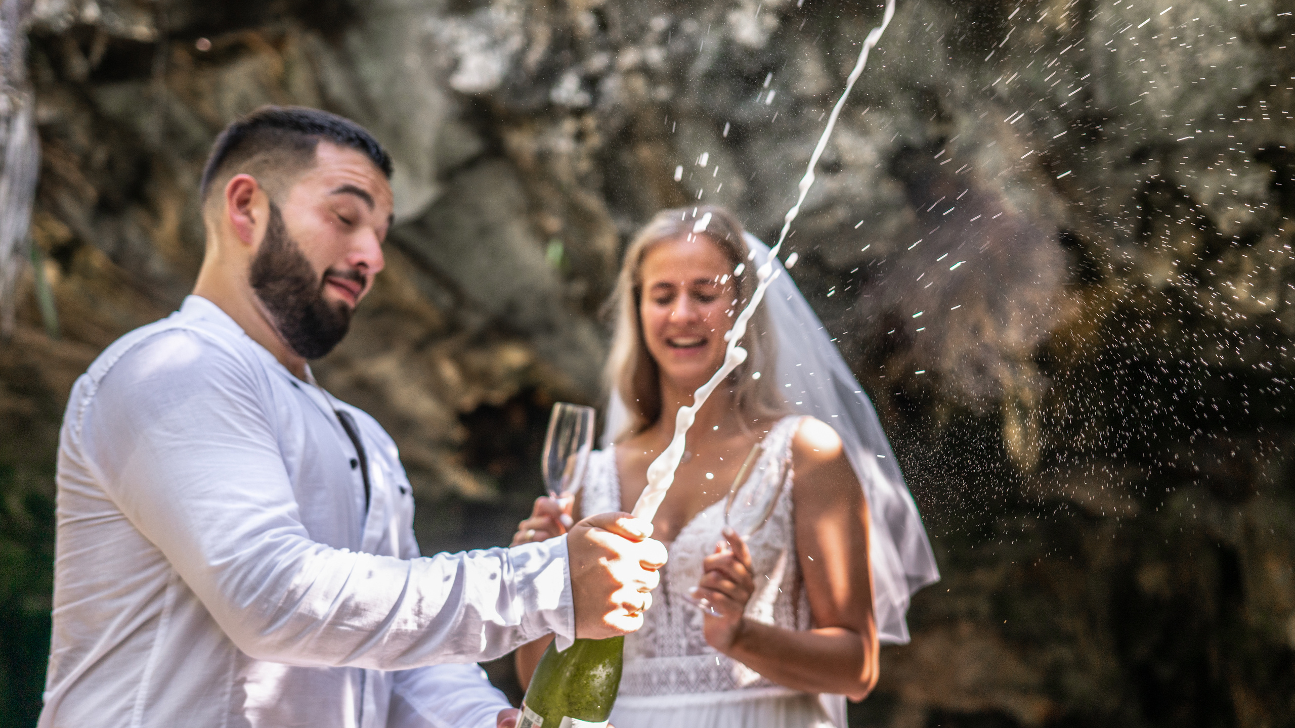 Bride smiling at groom during romantic cenote shoot