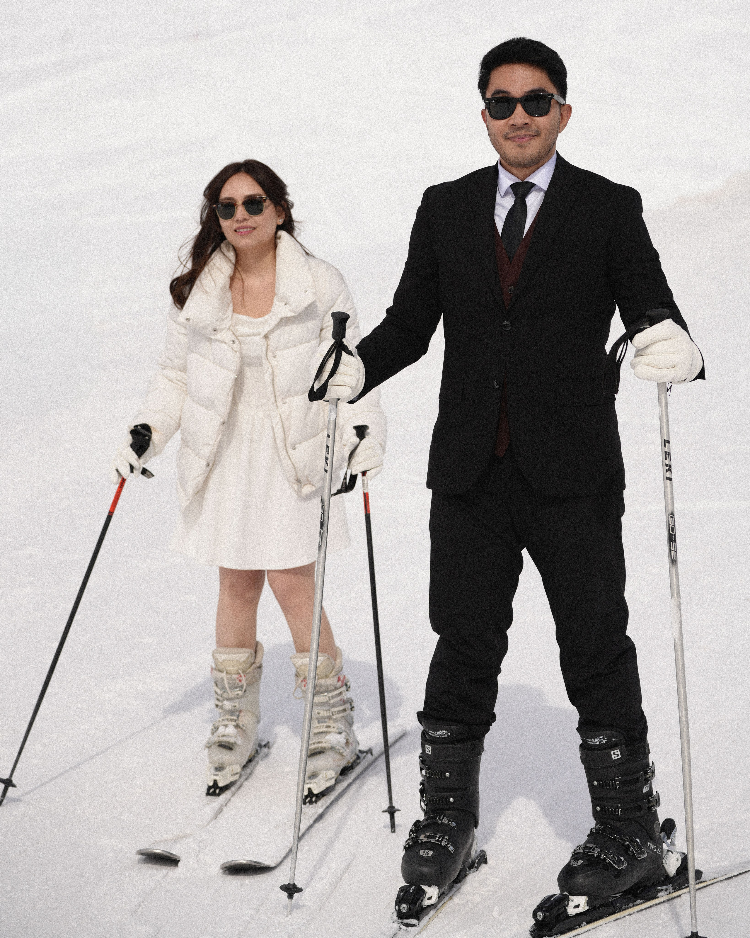 Couple skiing together during winter pre-wedding photoshoot in Gudauri