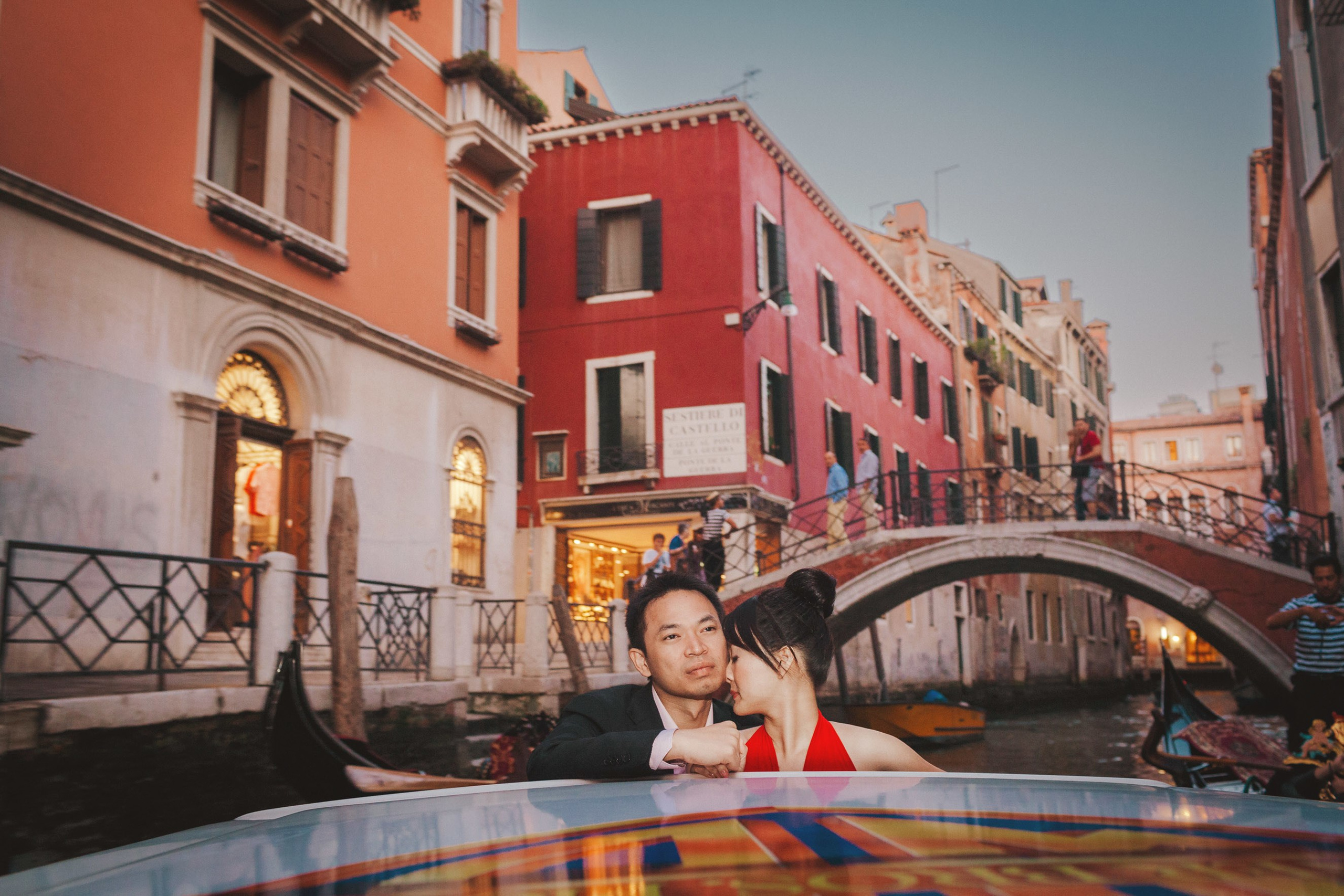 Gorgeous Thai couple embracing during private boat ride through Venice canals.