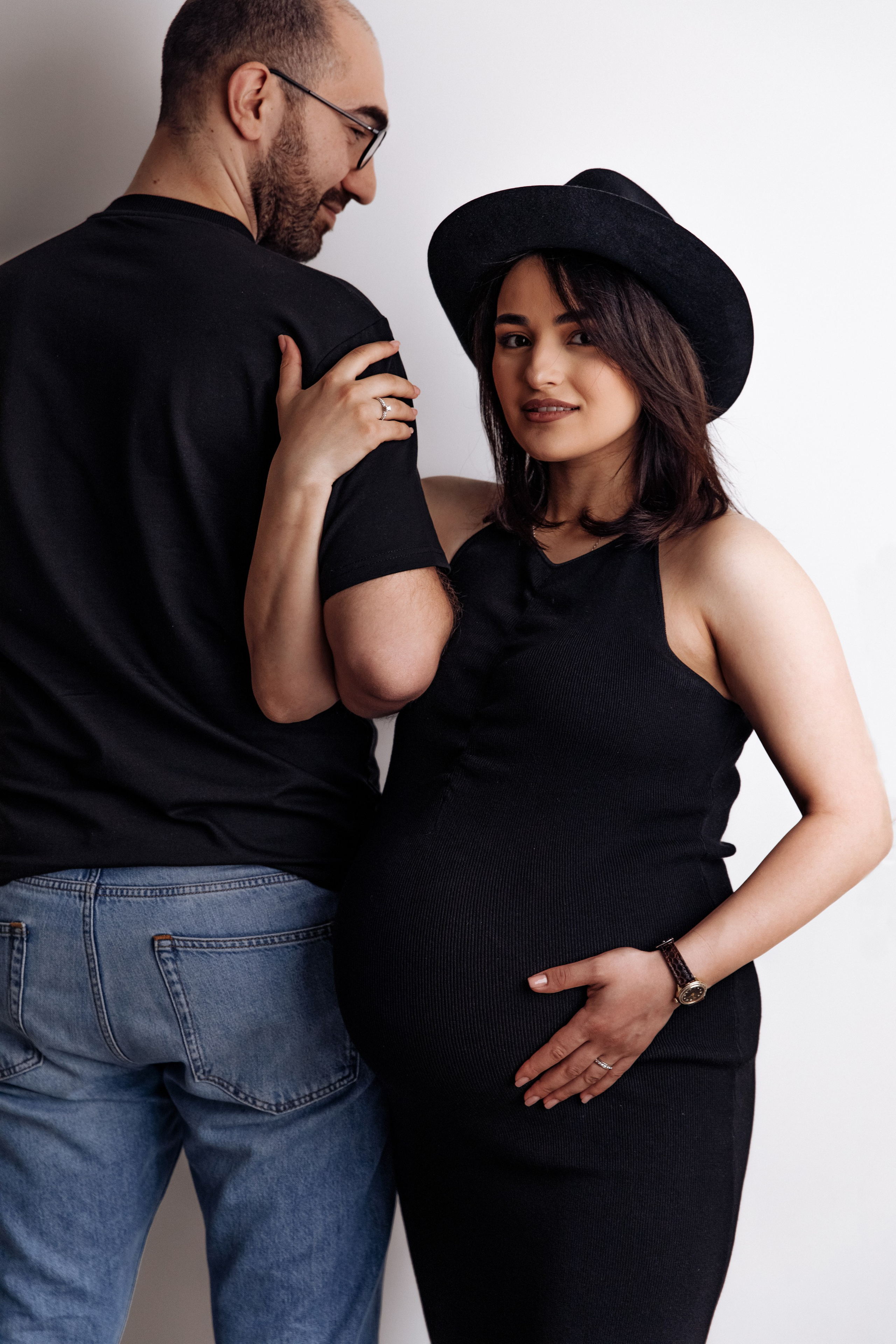 Werdende Eltern posieren stilvoll während eines Schwangerschaftsshootings im Fotostudio.
