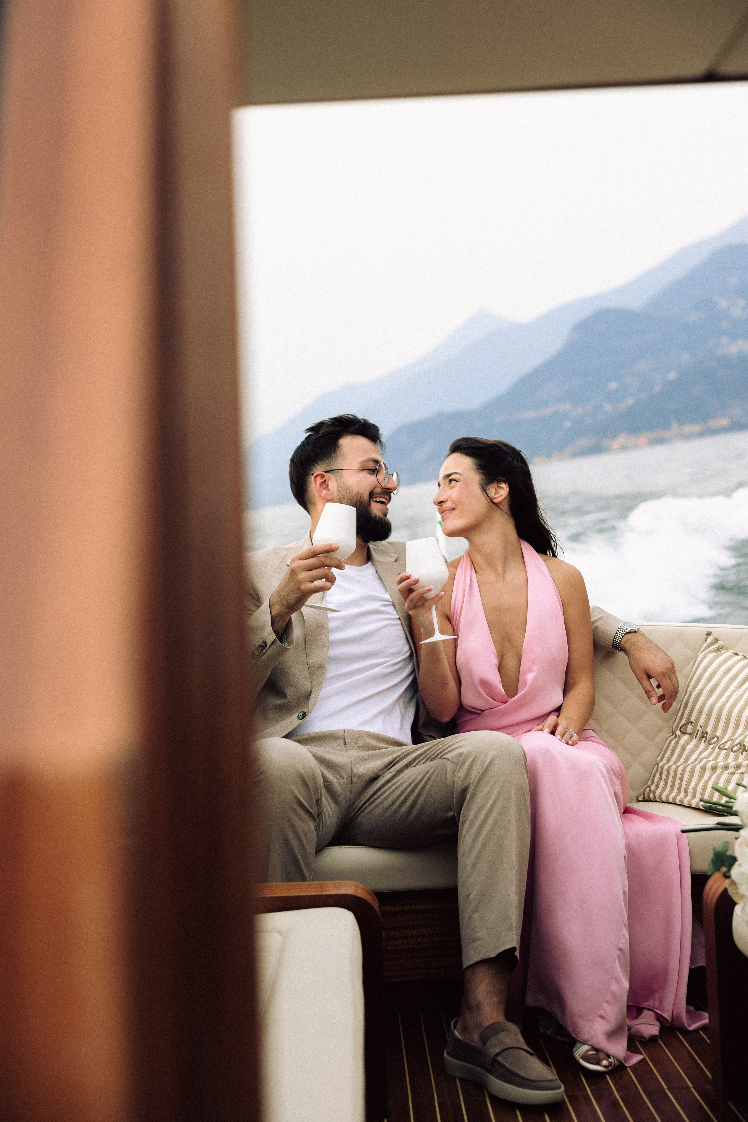 Newly engaged couple sharing a joyful moment on Lake Como