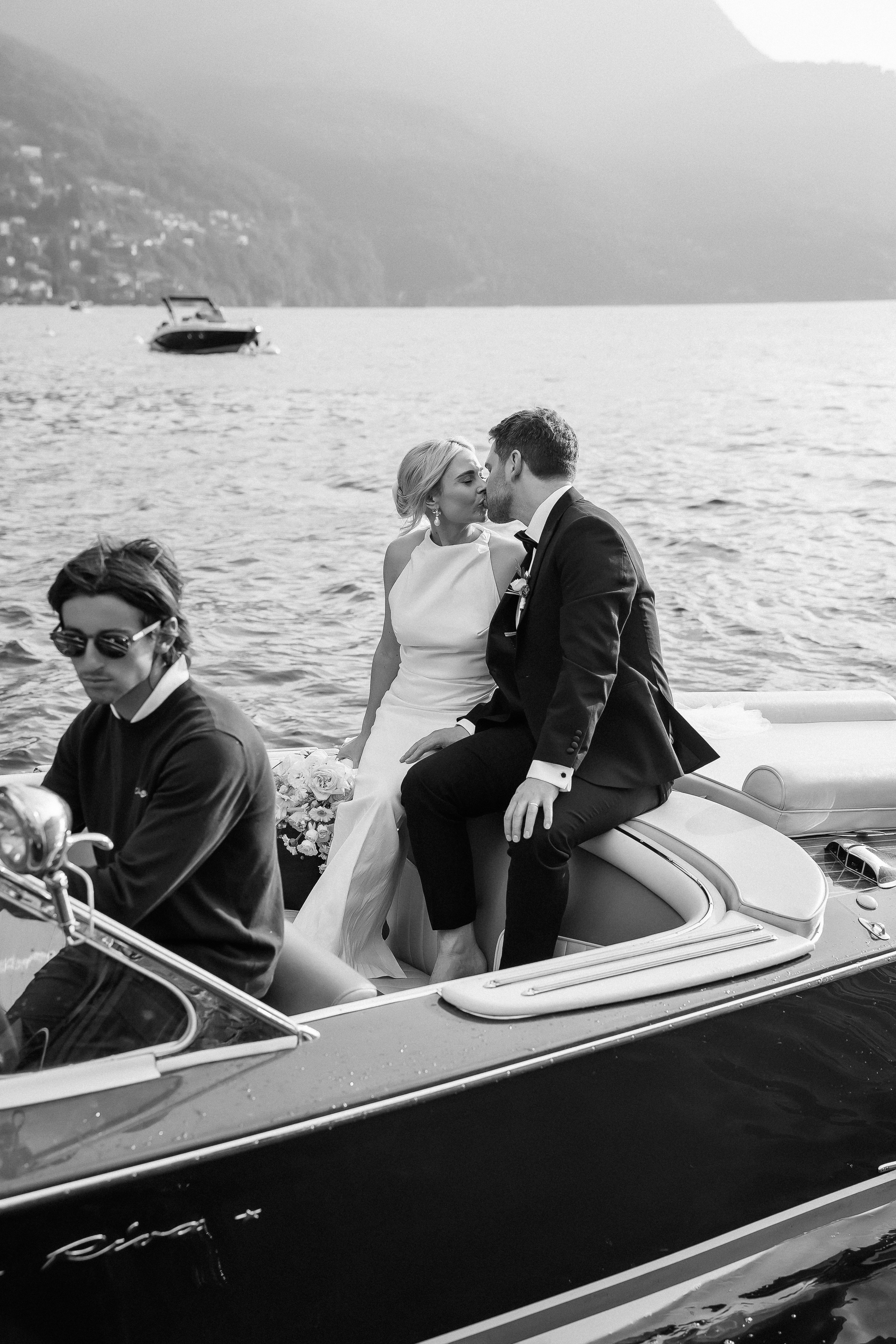 Black and white photo of the bride and groom on the boat at Villa Lario, Lake Como, Italy