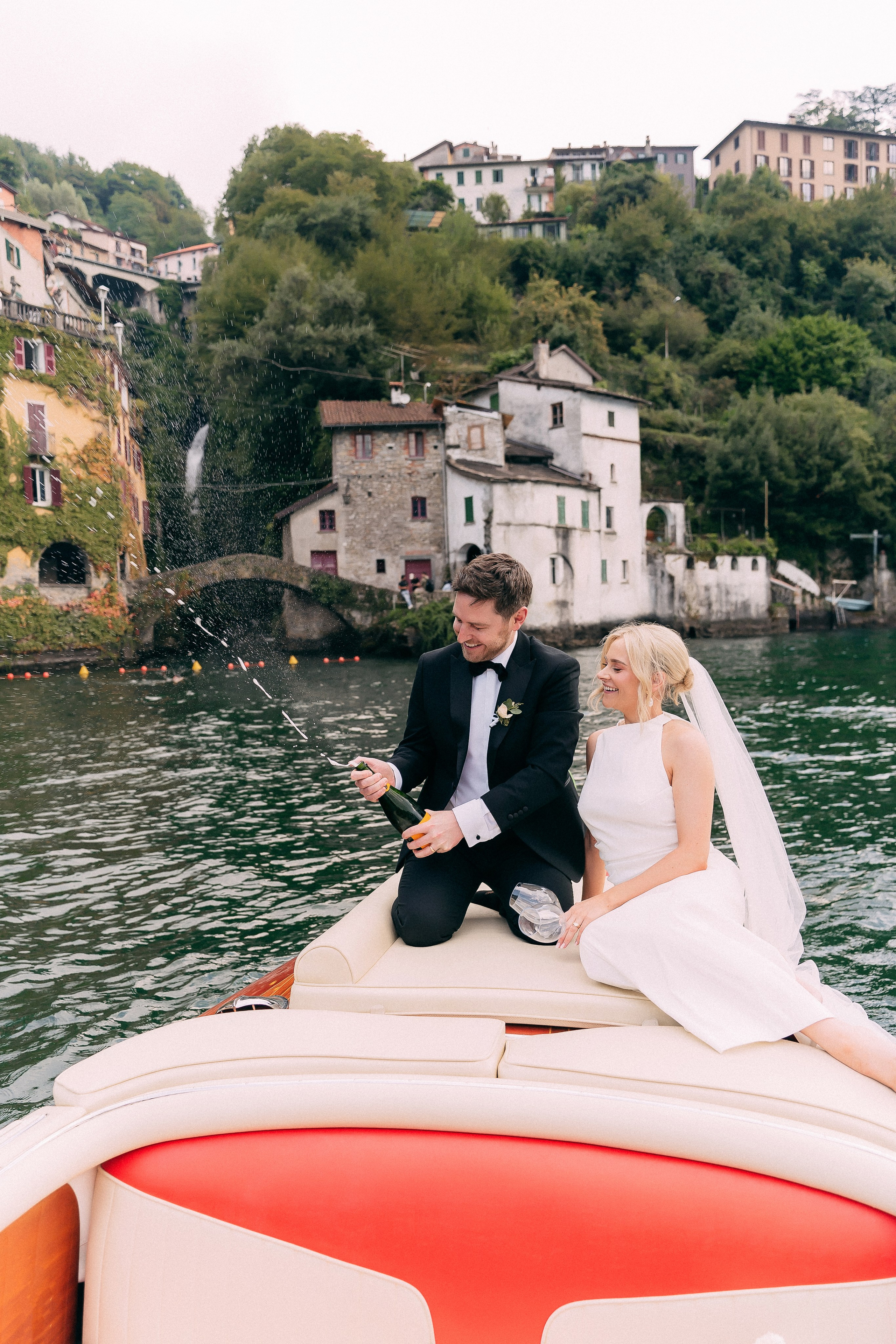 Bride and groom enjoying a boat ride at Villa Lario, Lake Como, Italy
