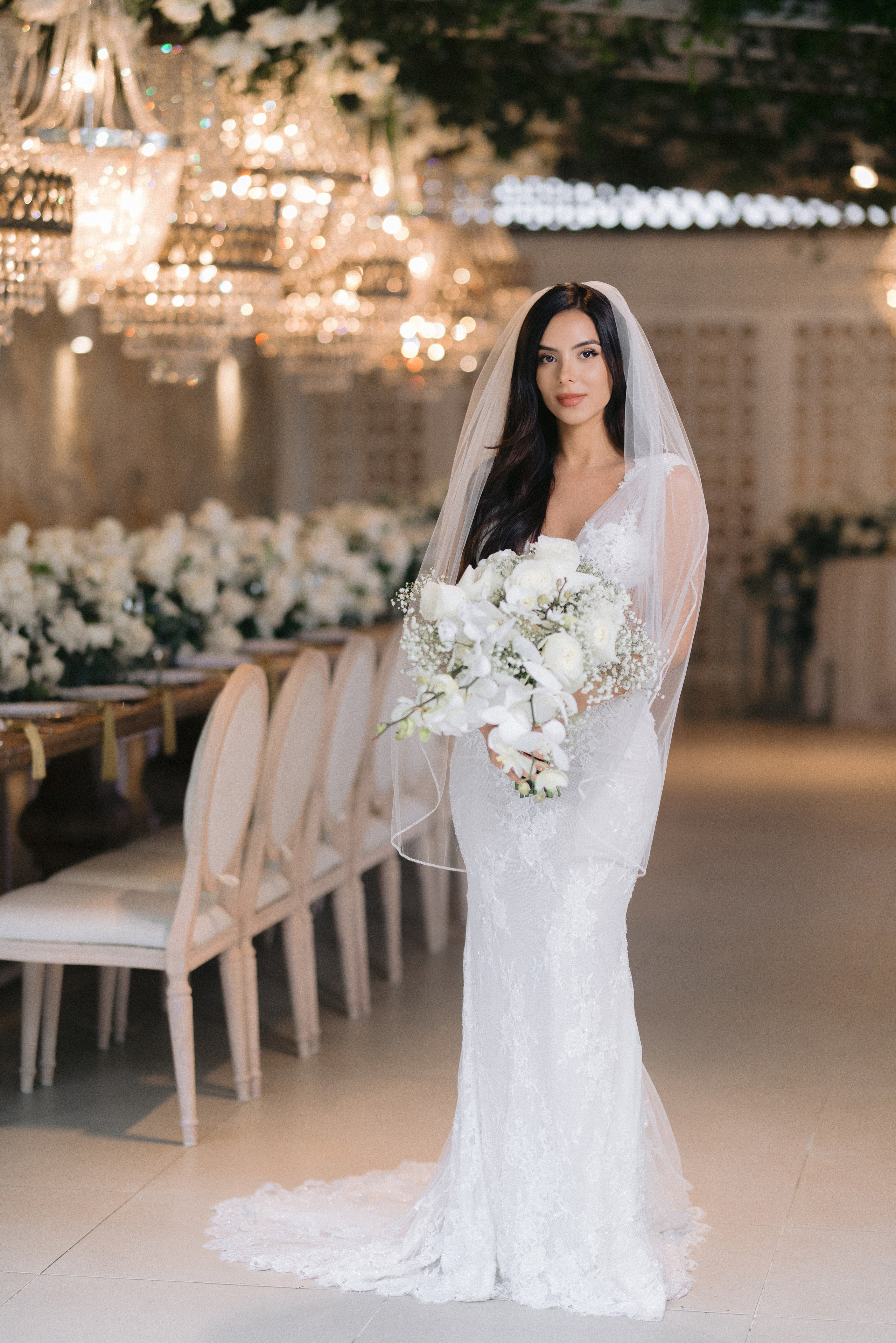 An elegant bride in a white dress holding a bouquet