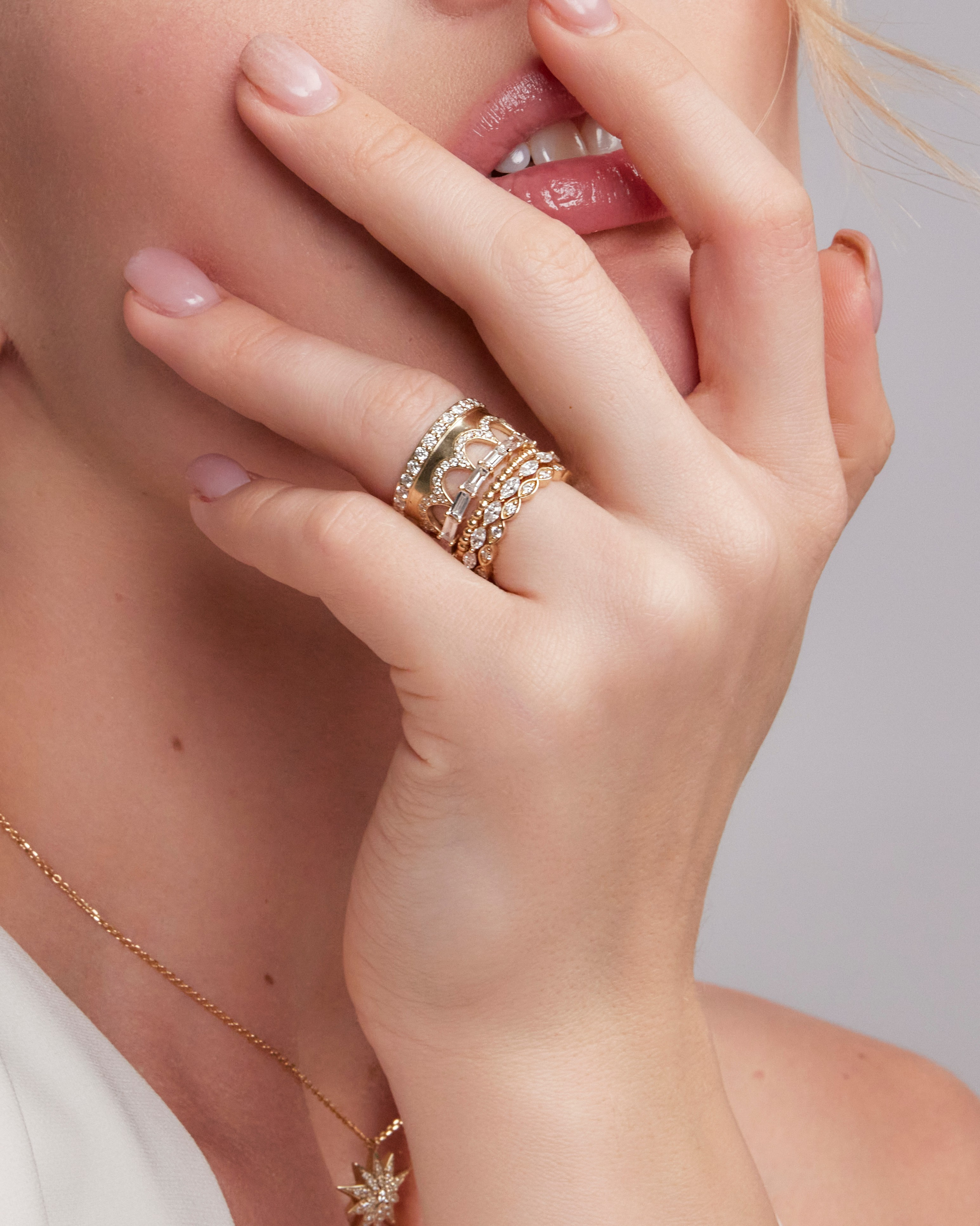 Close-up of stacked diamond and gold rings, highlighting intricate details and premium craftsmanship.