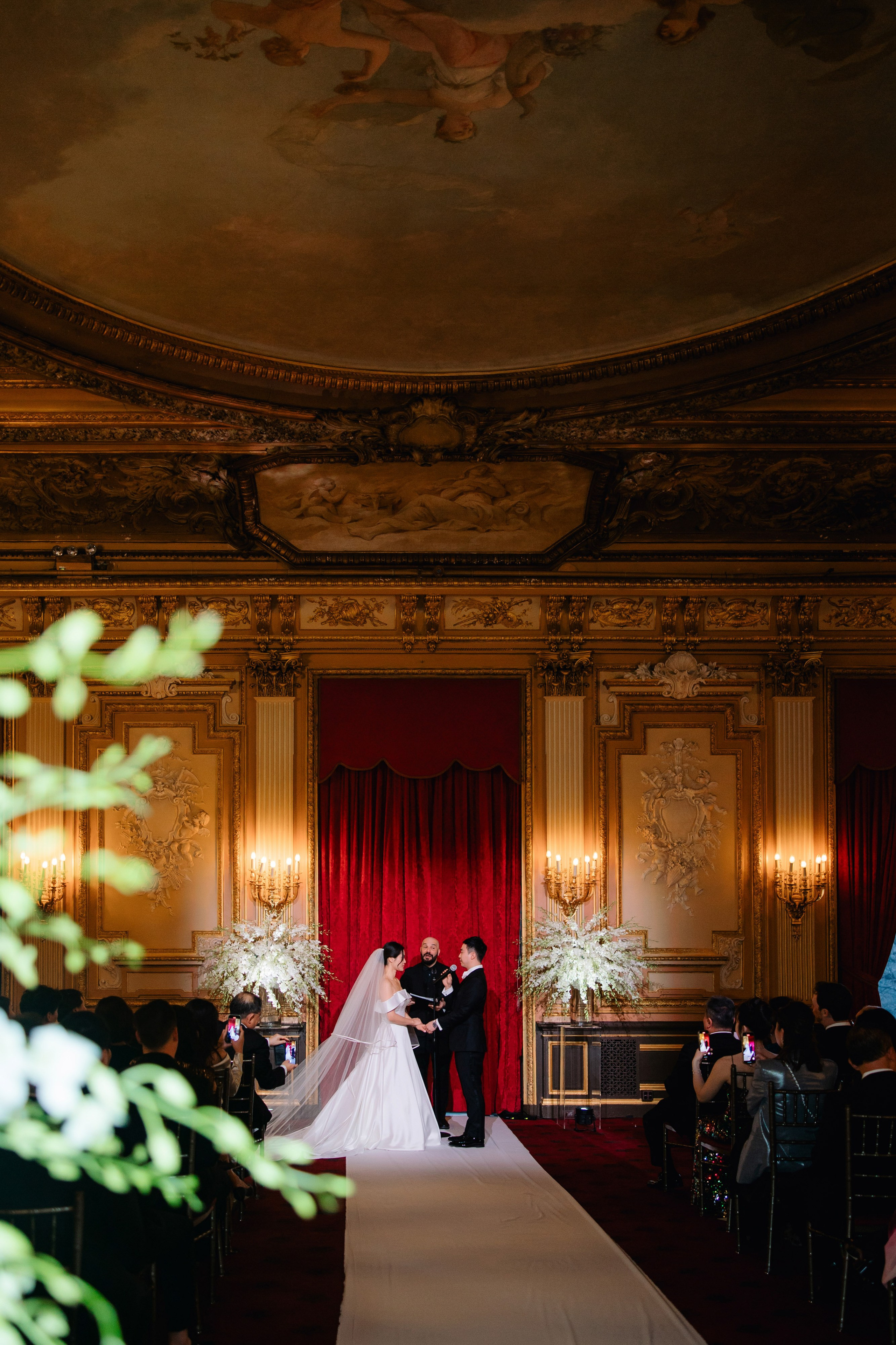 a bride and groom are standing in a room