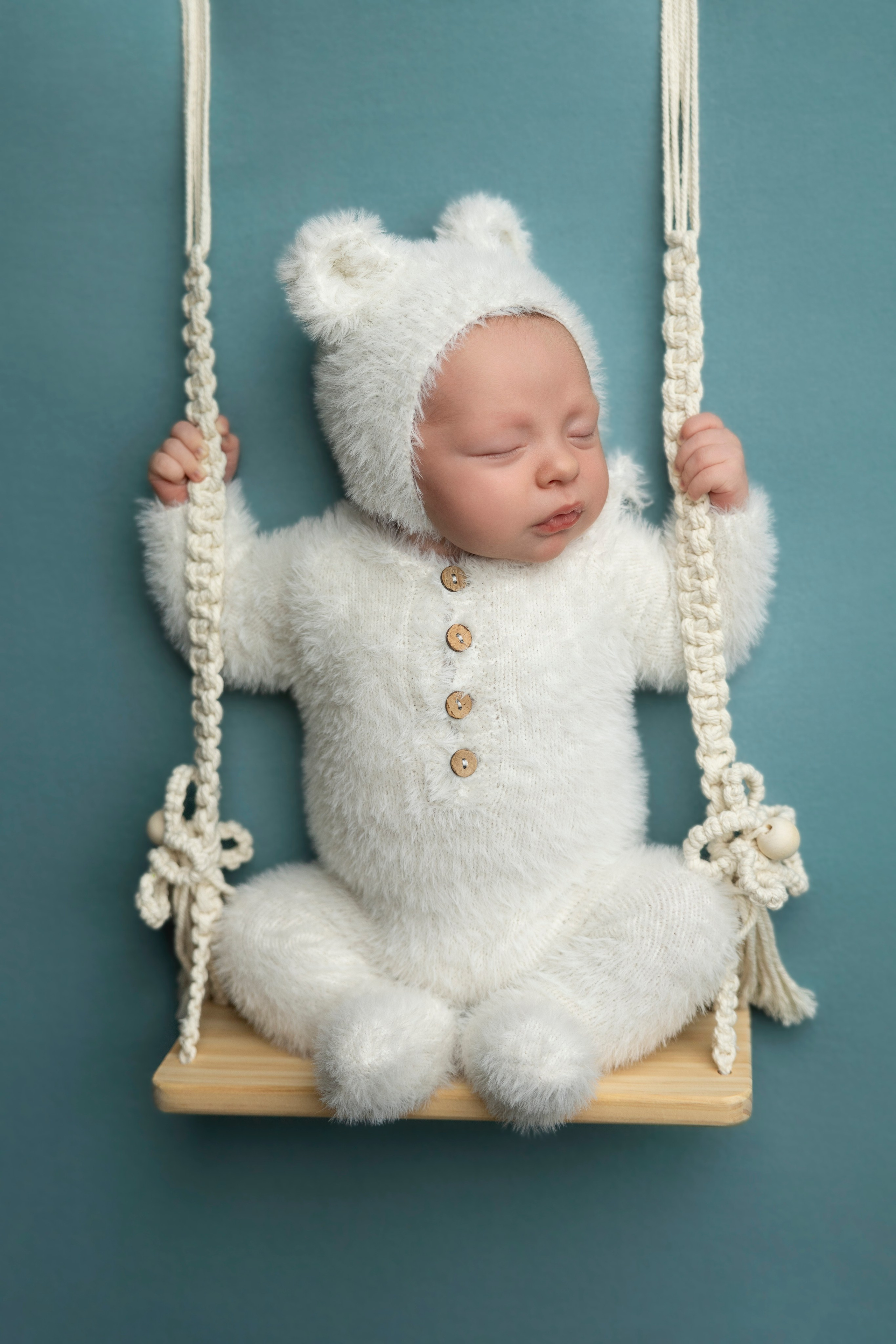 white baby bear in the swing