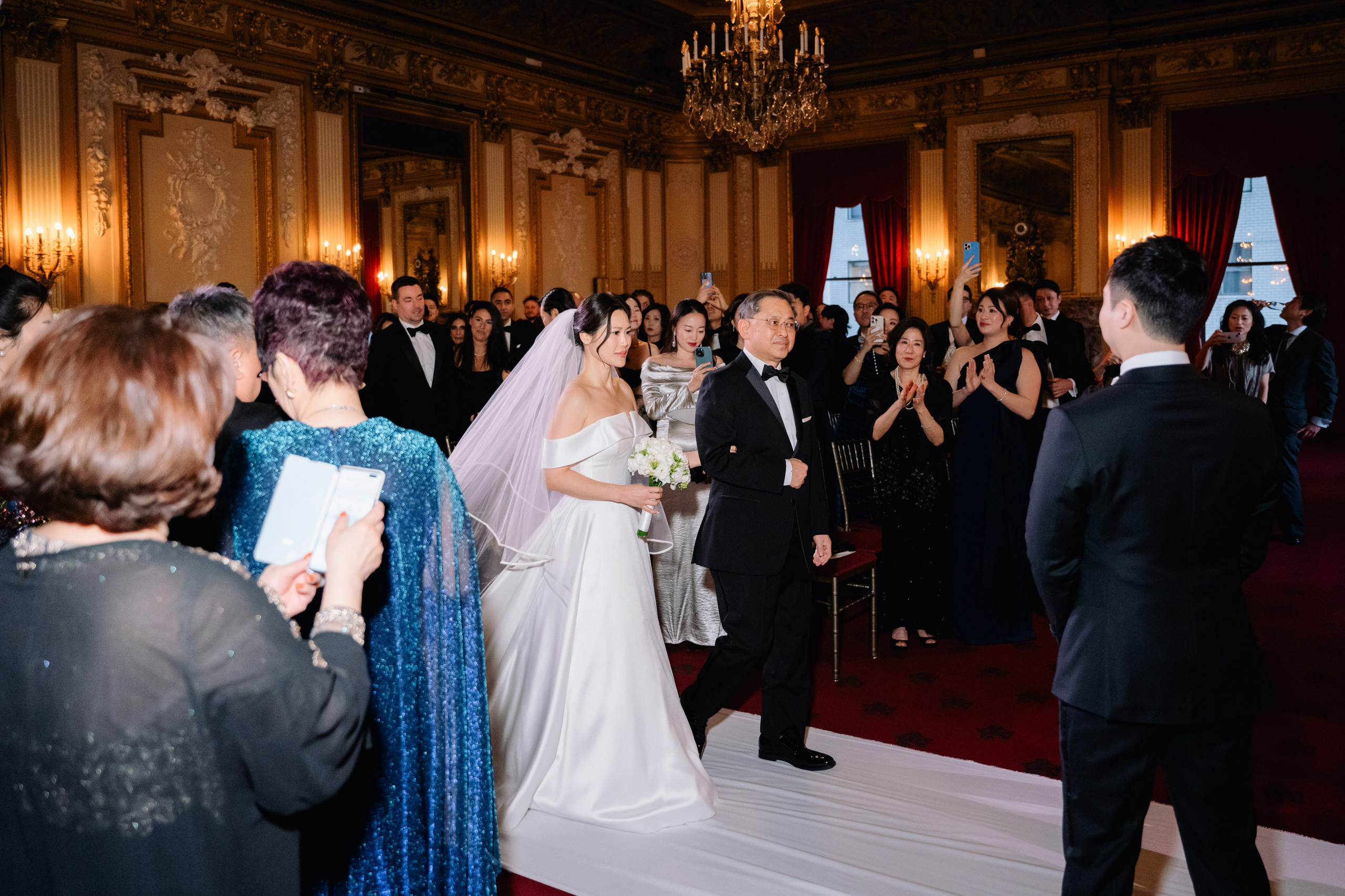 a bride and groom walking down the aisle