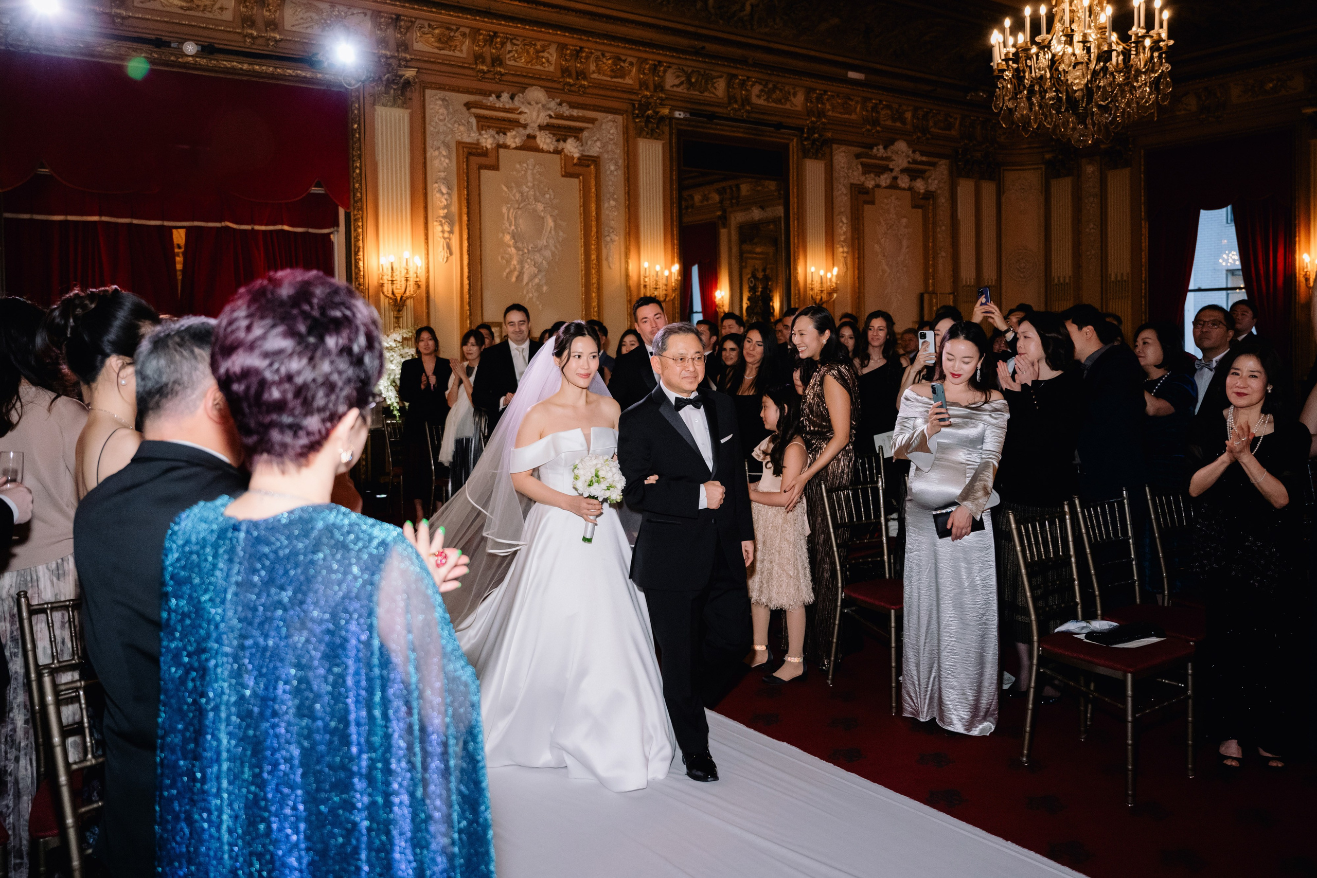 a bride and groom walking down the aisle