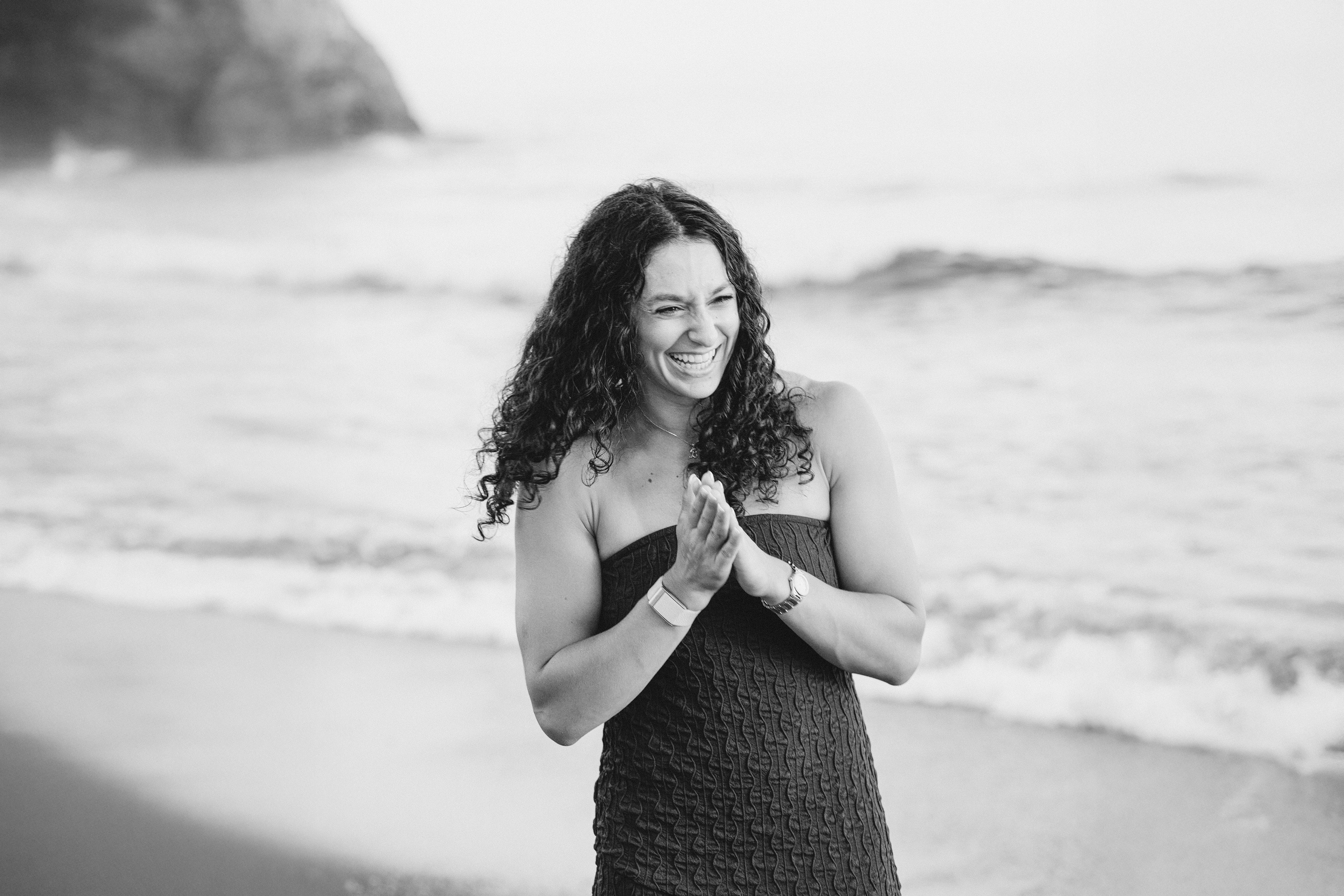 Black and white portrait of a bride during a destination engagement celebration in Málaga, Spain. Joyful proposal memories captured by the sea during a romantic beach session.