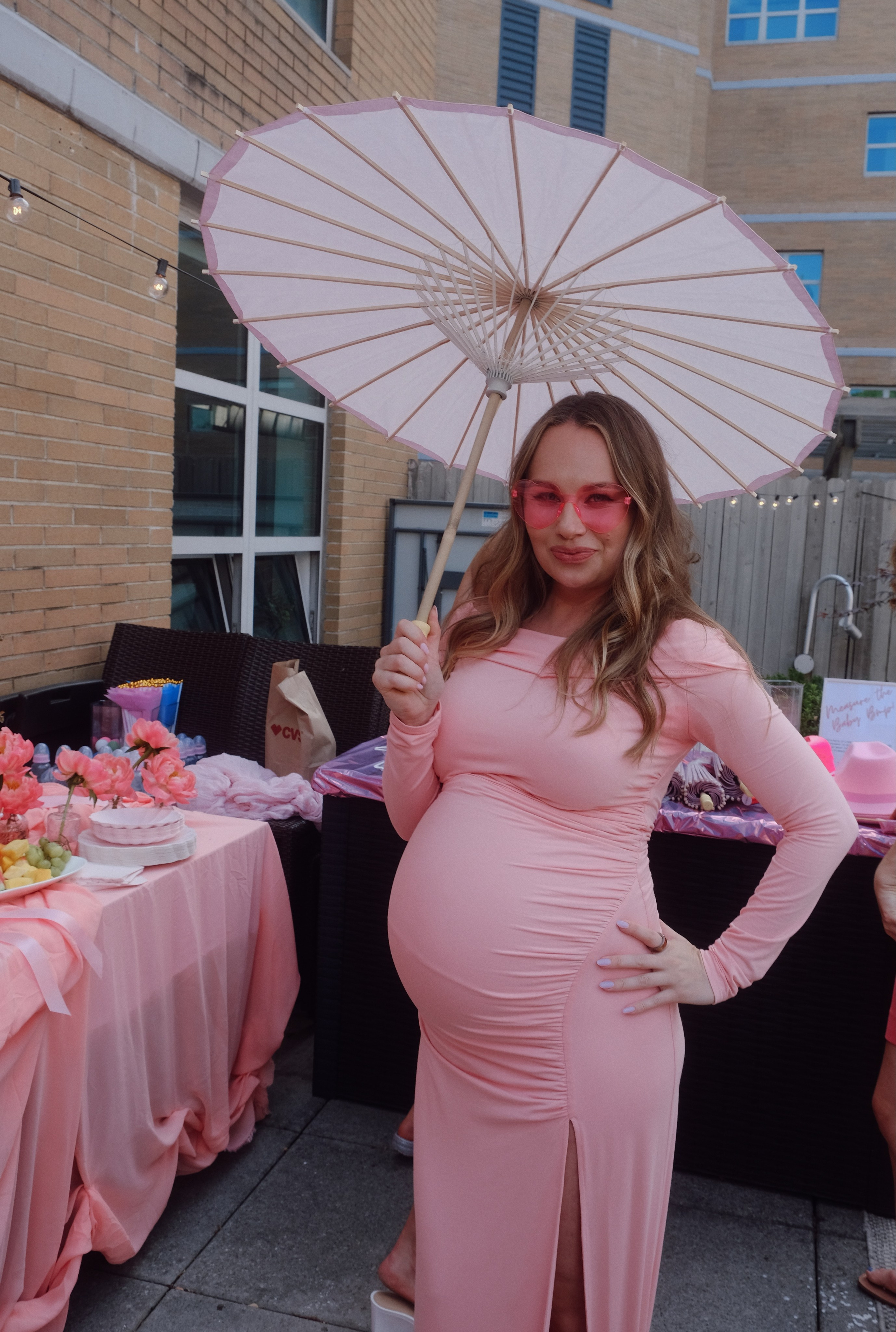 Pregnant woman smiling at her baby shower celebration