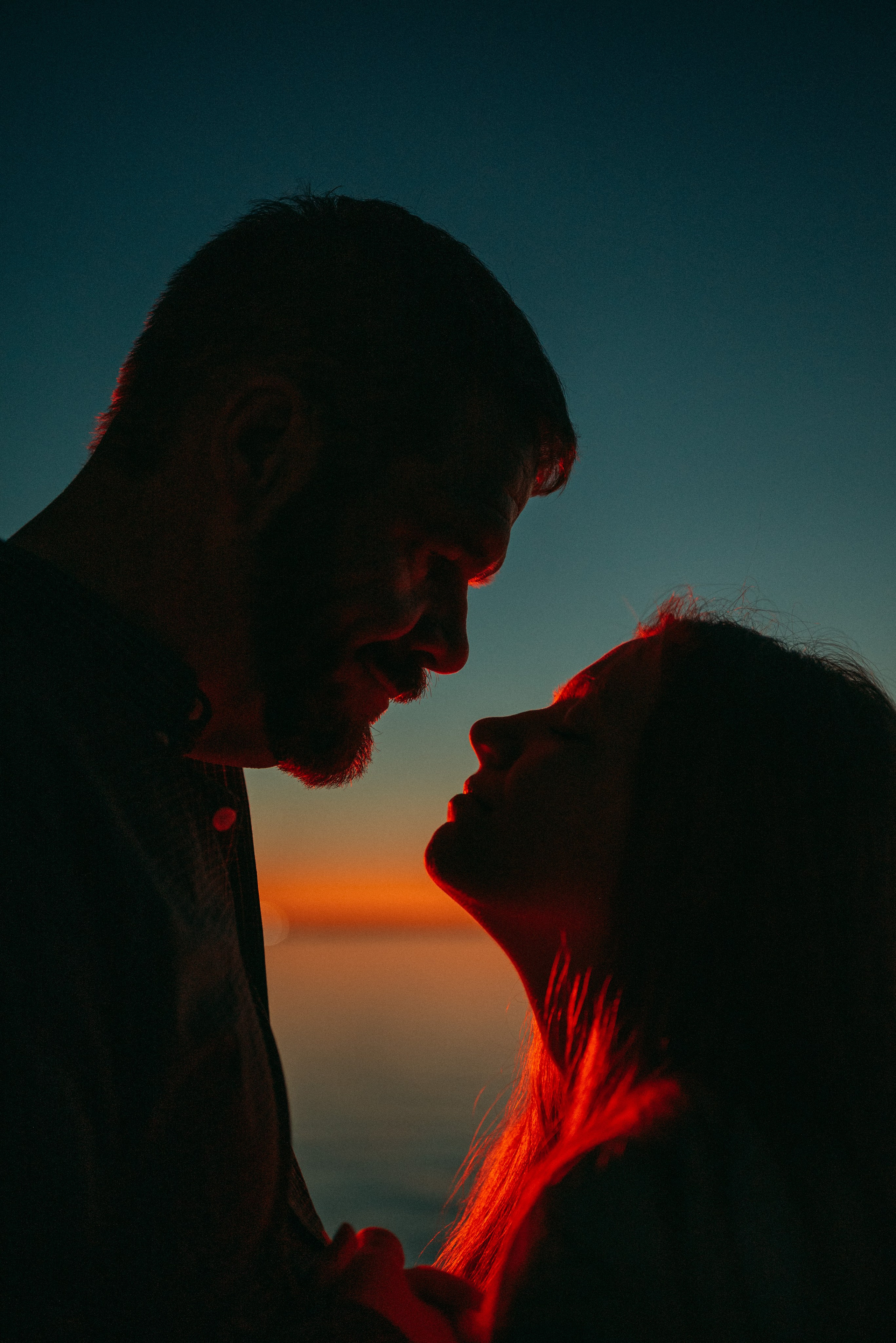 Happy couple looking at each other against the sunset in Green Bay, Wisconsin. 
