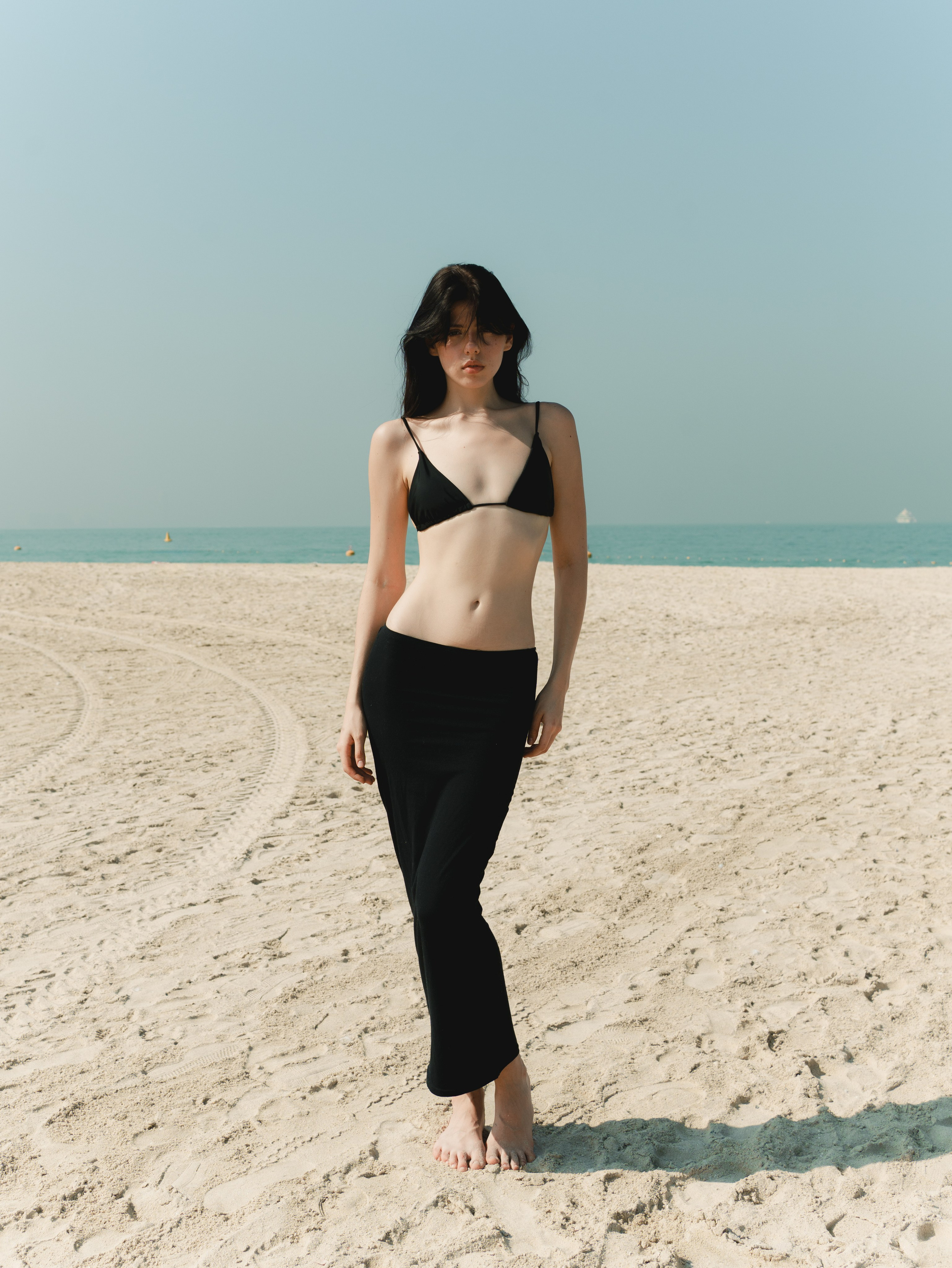 Fashion portrait series on the beach in minimalistic swimwear look. Alisha Geva | Contemporary fashion women’s portrait Dubai