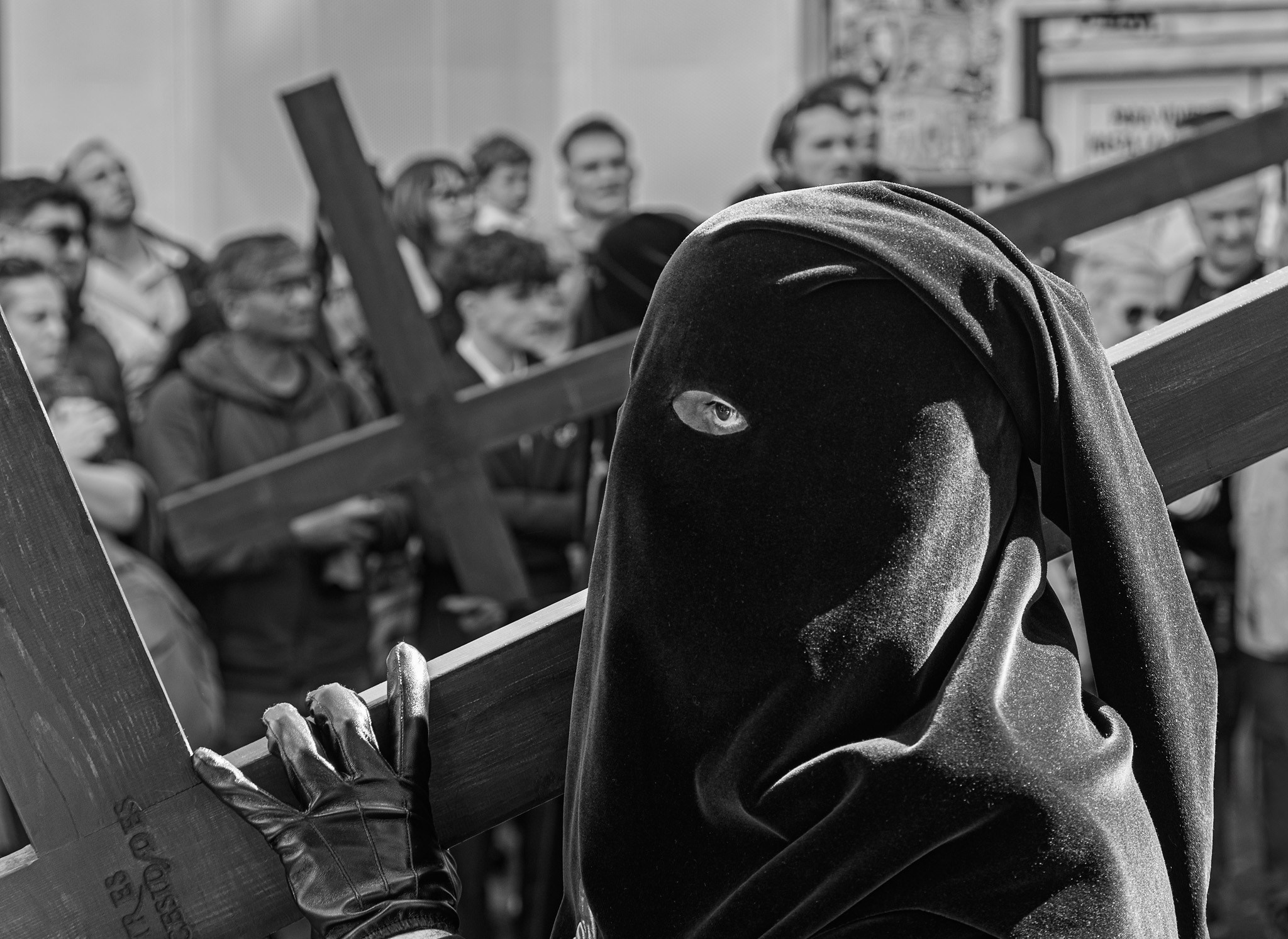 Penitent carrying wooden cross during Semana Santa procession