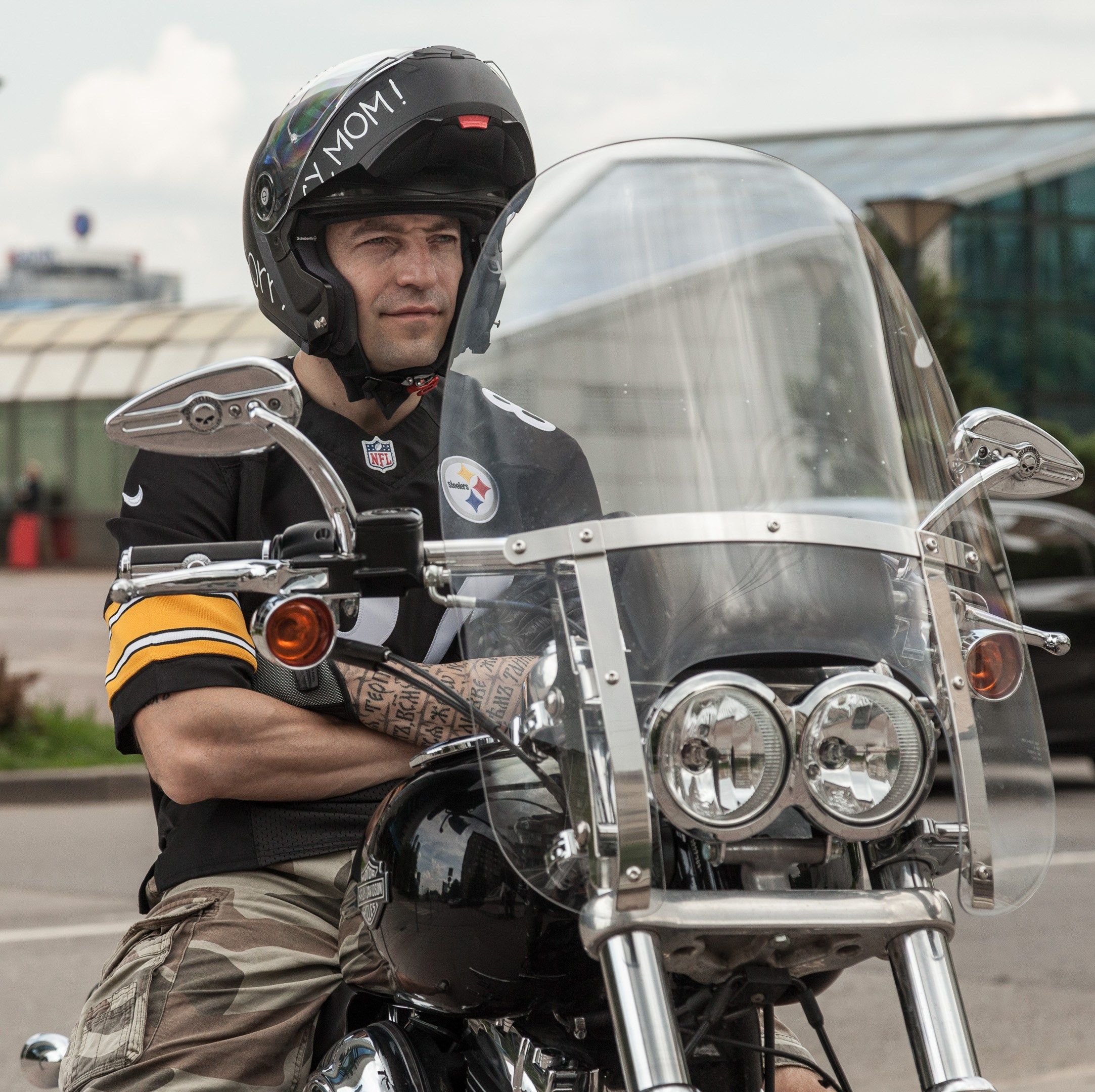 Location portrait of a biker on a Harley Davidson motorcycle in city landscape - photographer Andrey Dunin