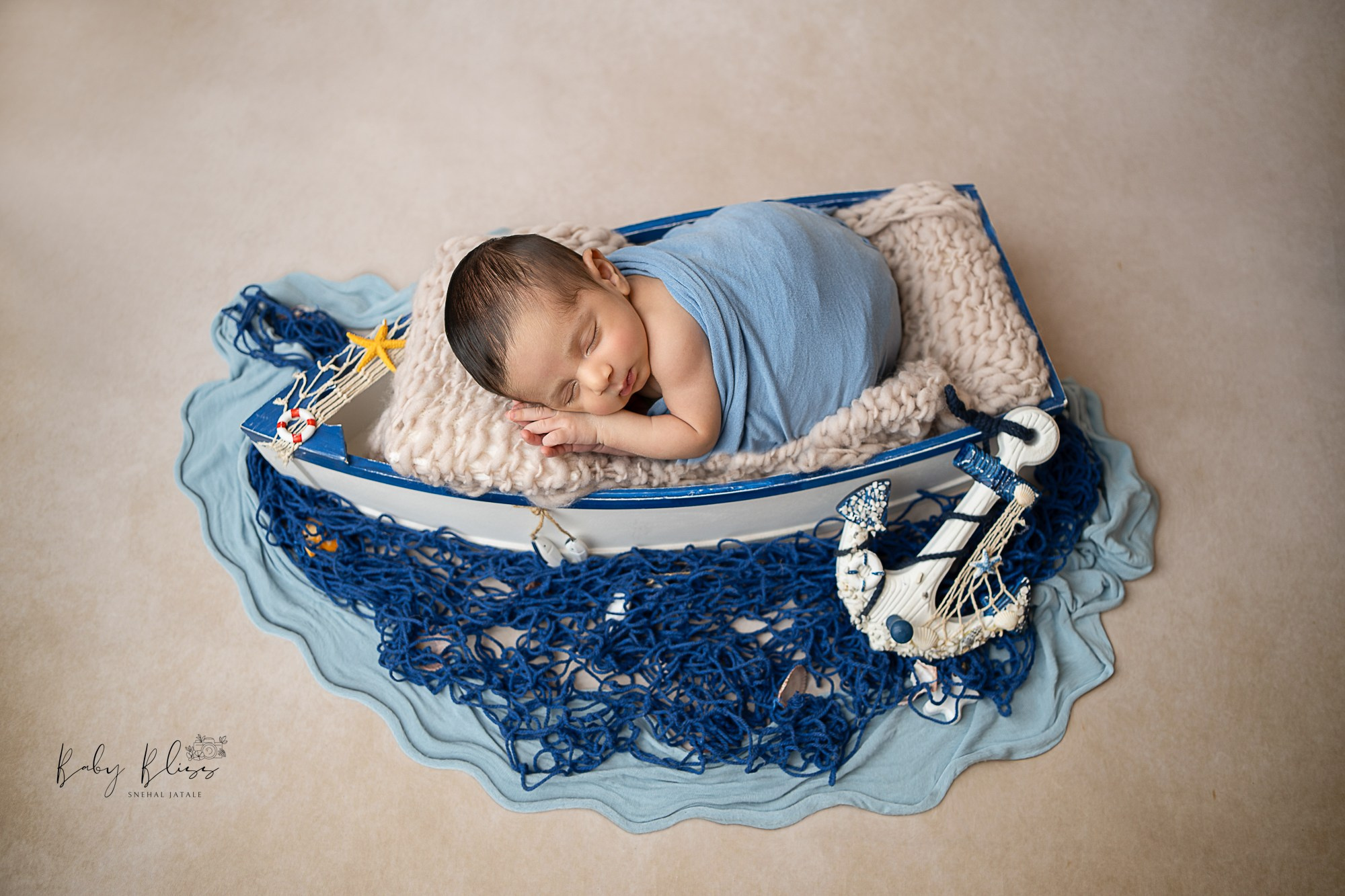 sailer themed newborn setup for newborn baby photo shoot captured by female photographer in Doha