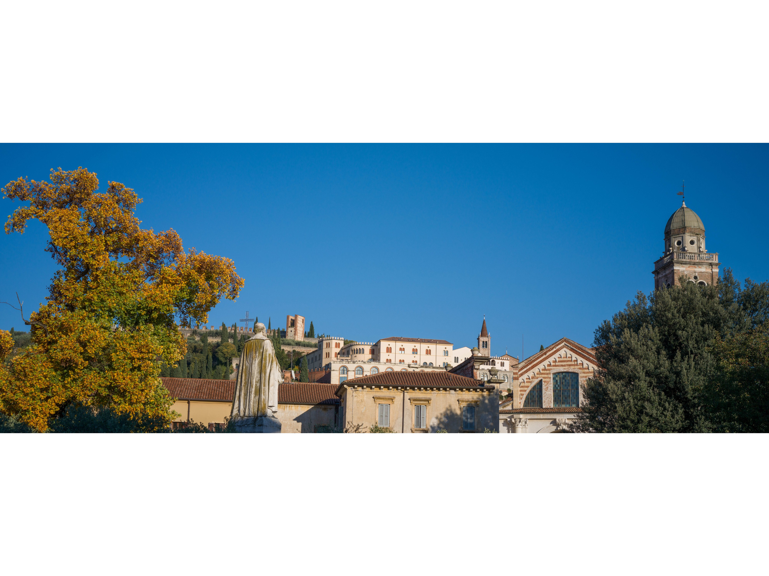 Historic architecture and cathedral dome in Verona under clear blue winter sk