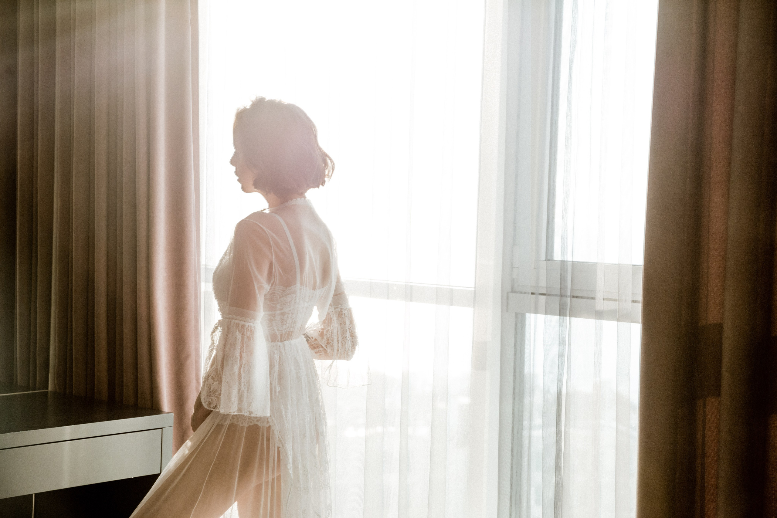 Bride getting ready boudoir style before seaside ceremony, wedding photography France