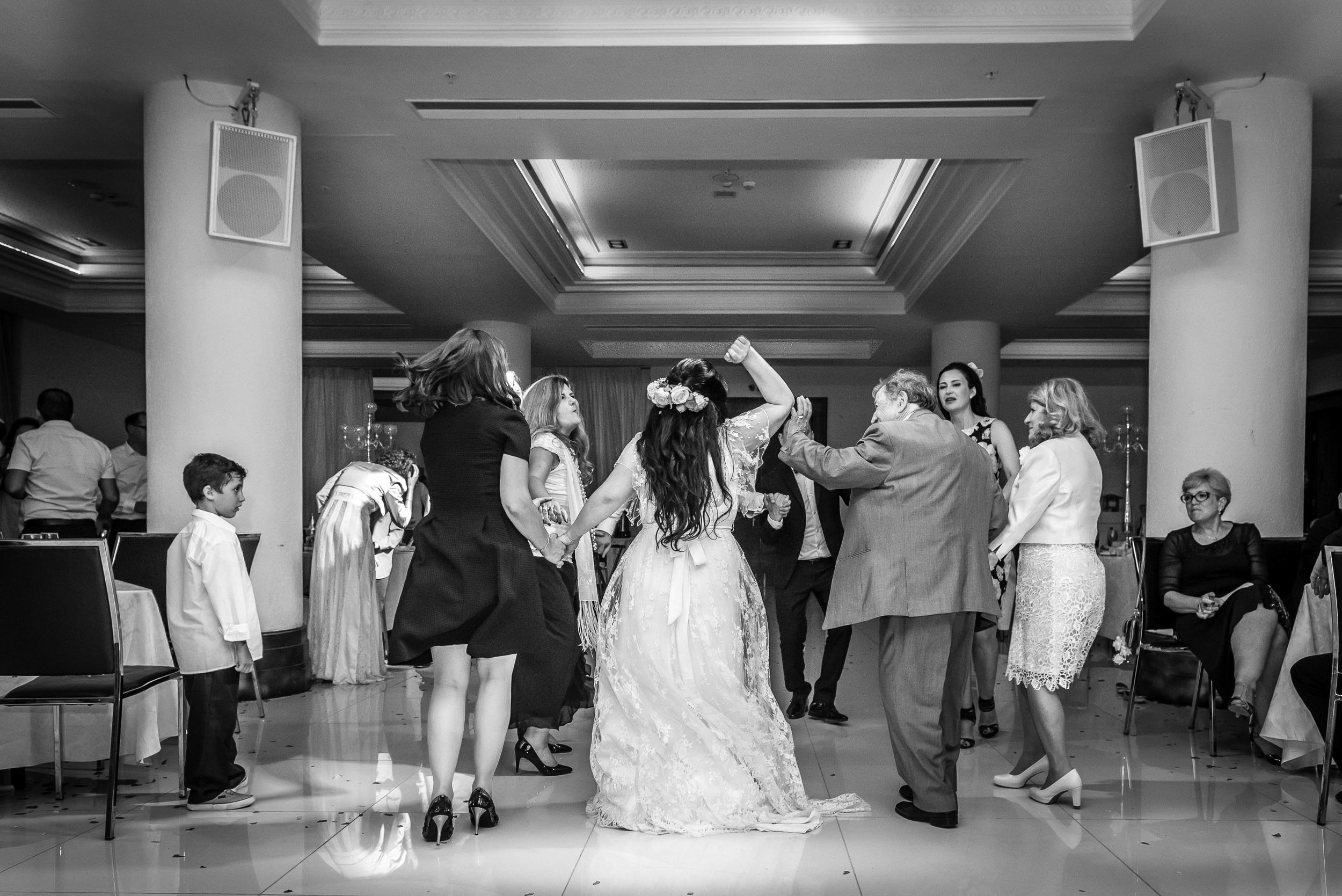 Bride Simone dancing in a circle with guests during the reception at the Leonardo Hotel in Haifa, Israel